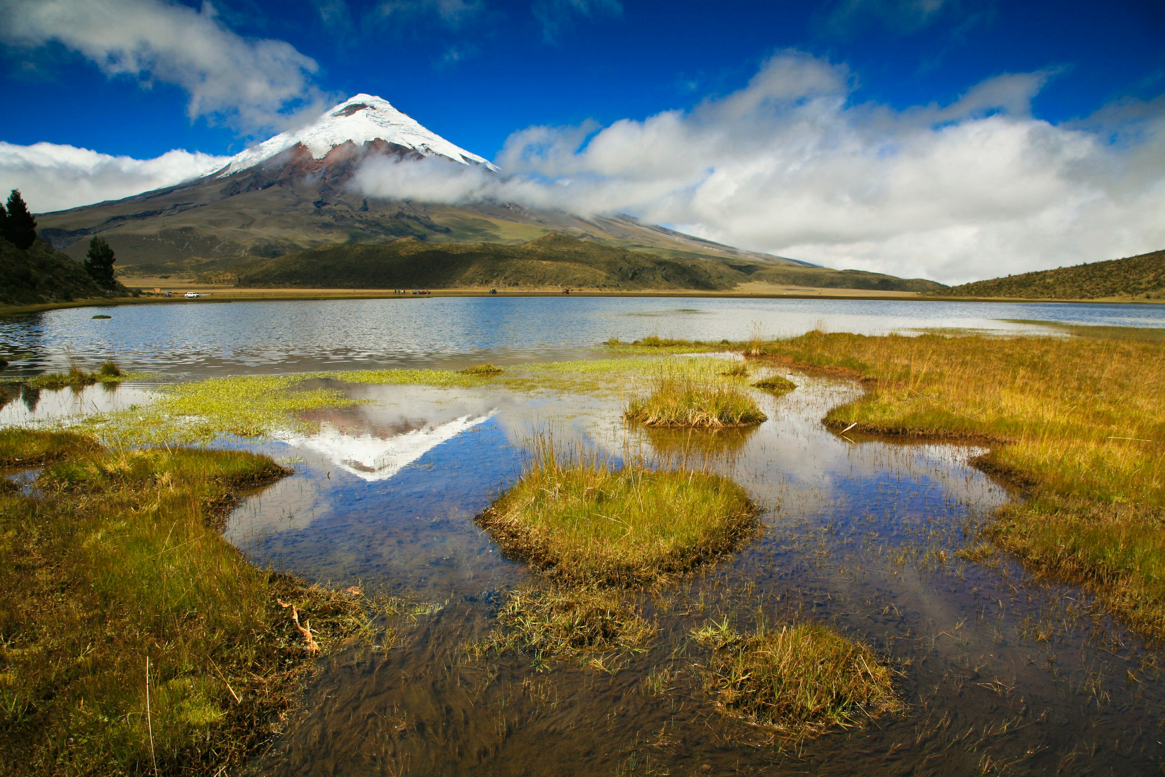 Cotopaxi landscape, with a cloudy sky above reflected in the waters below.