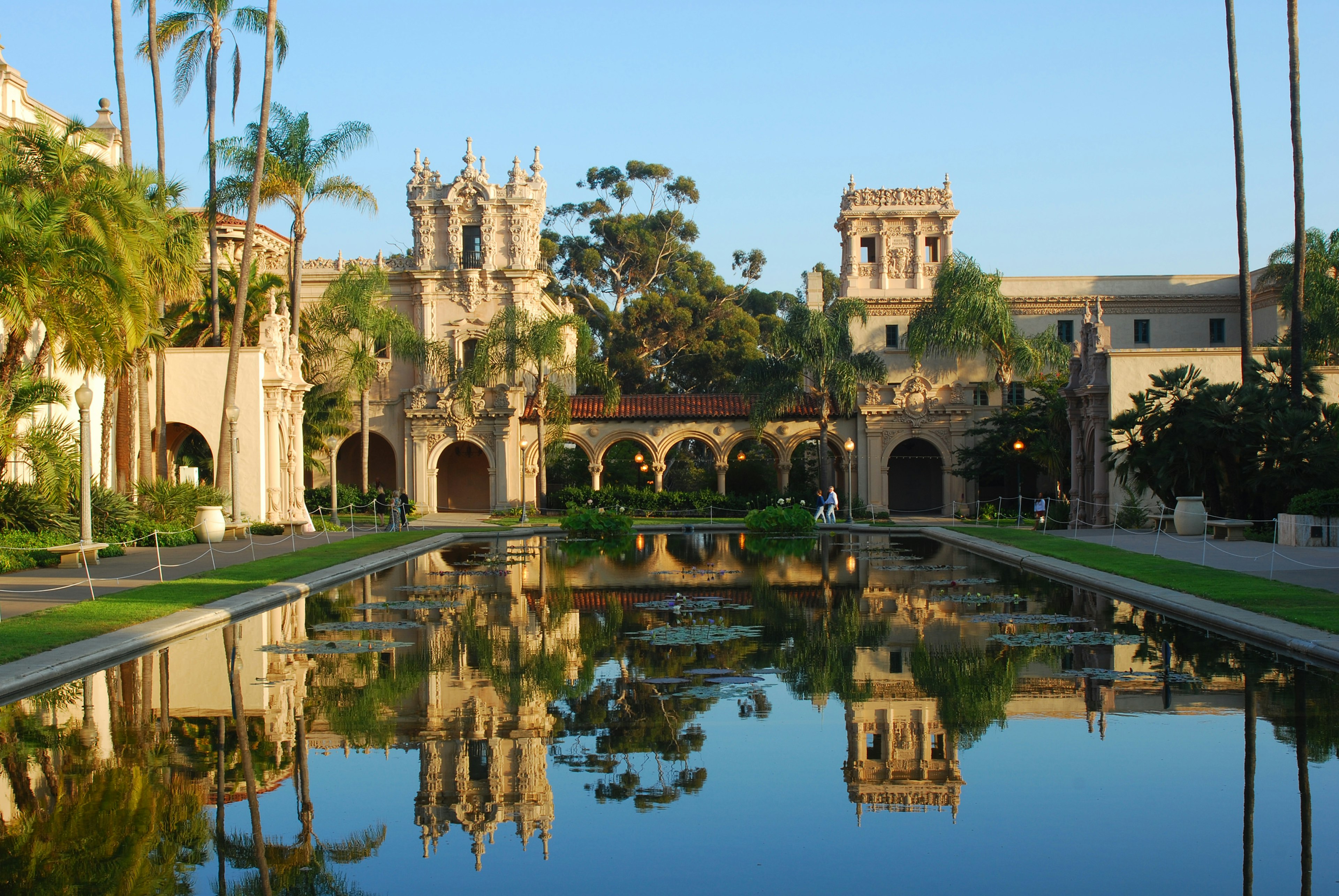 Balboa Park with buildings reflected in still water.