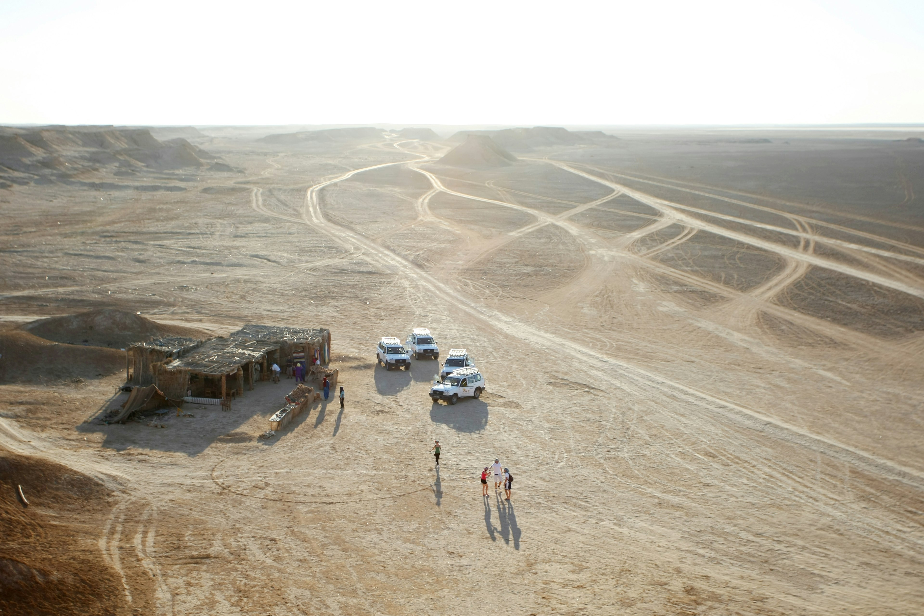 Tourists at the camel head rock, one of the tourist stops in Ong Jemel, Tozeur, Tunisia. Ong Jemel is the place near Tozeur, where the movies Star wars and the English Patient were filmed.