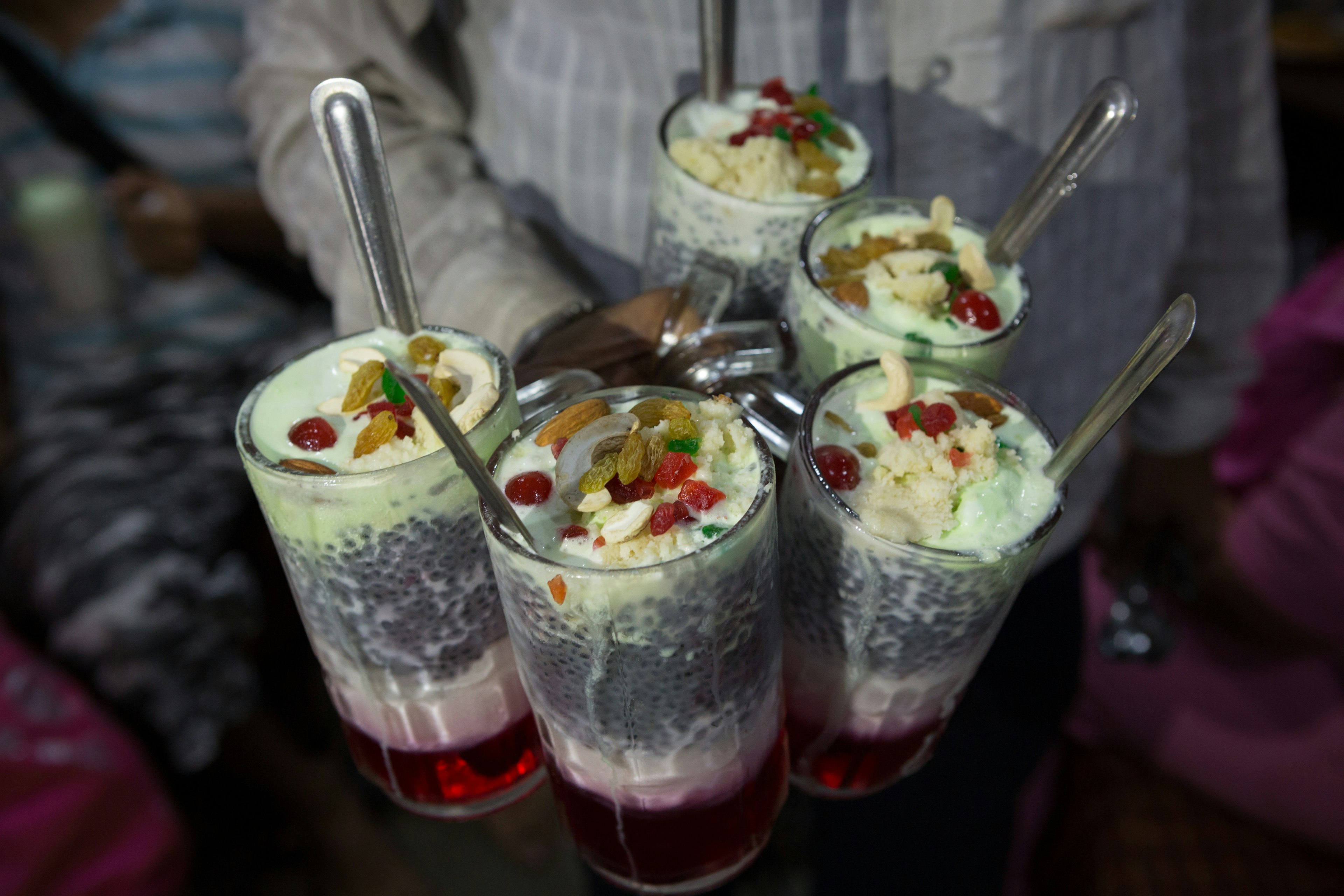 A popular south asian drink made with kulfi or ice cream, Rose Sharbat, Sugar, Tukamaria seeds and milk.