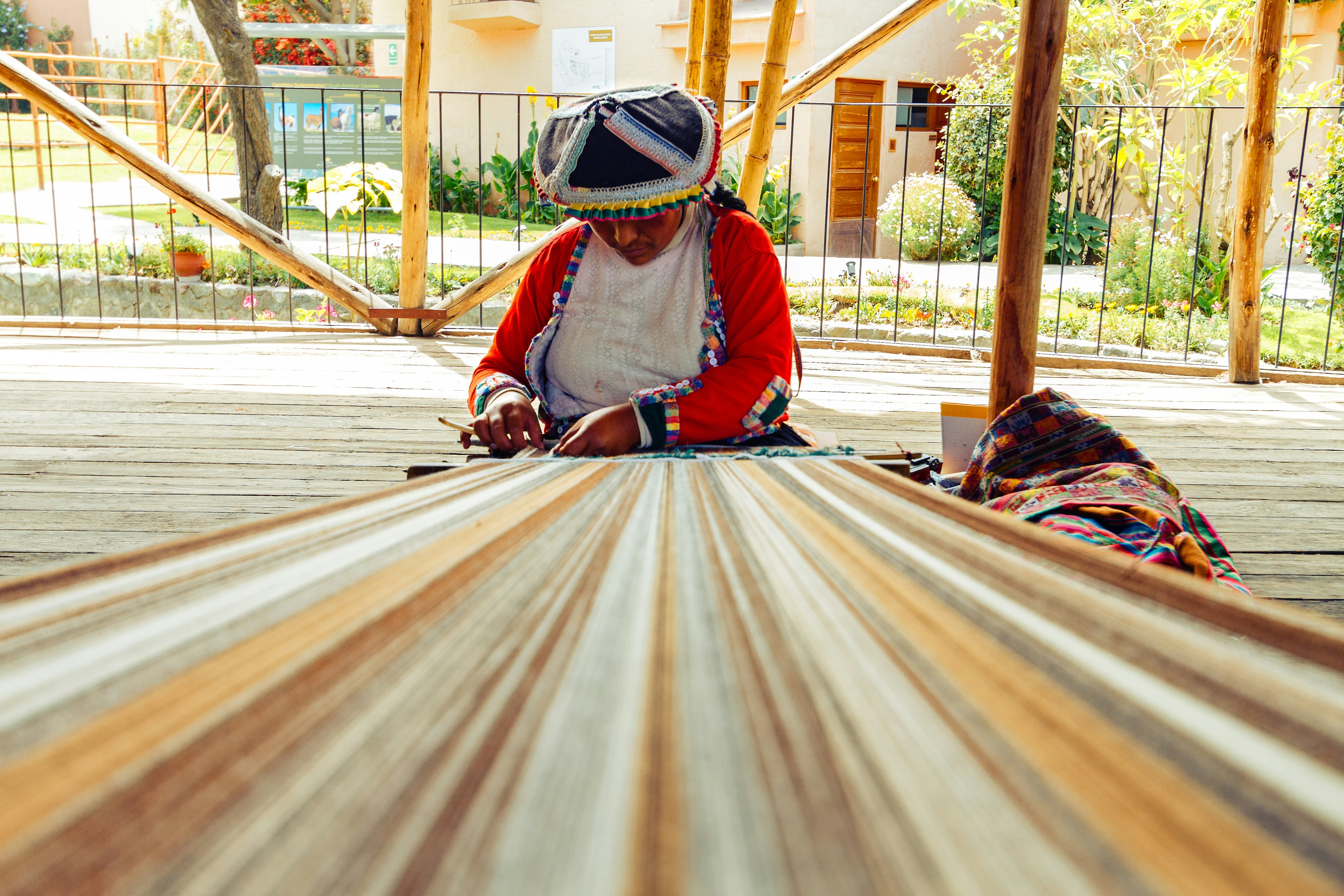 A Peruvian woman weaves on a loom in Arequipa