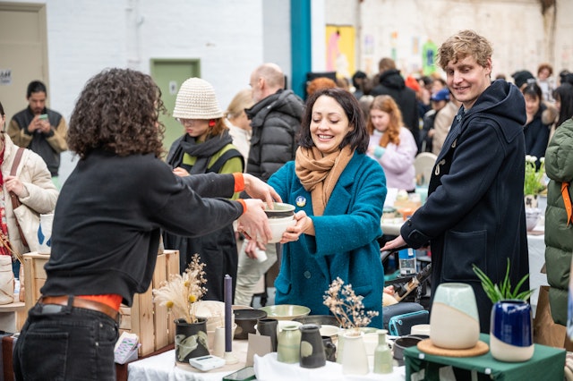 Customers purchasing ceramics at DIY Art Market