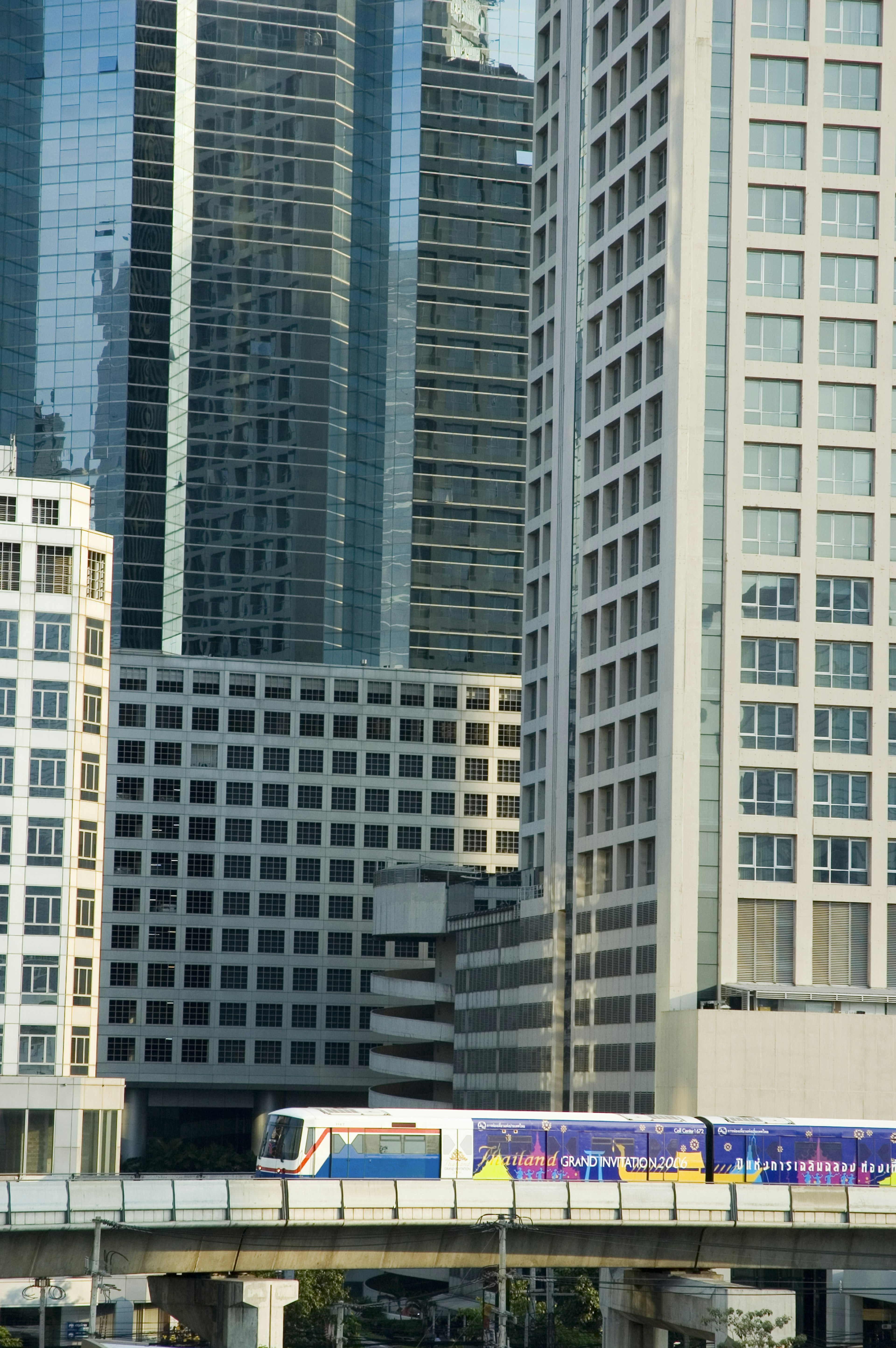 The BTS Skytrain weaving through city buildings in Bangkok