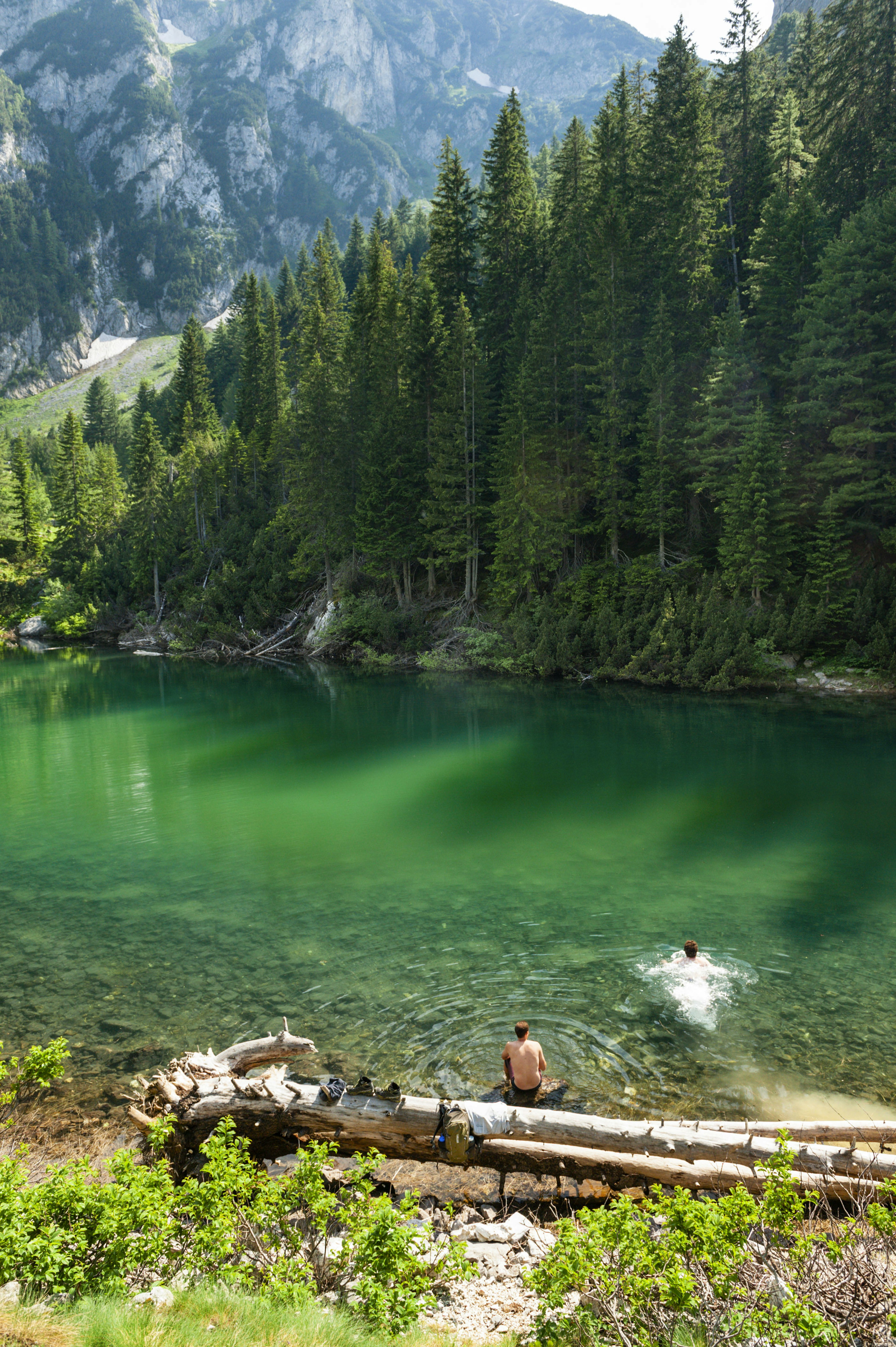 Two men swim in the glacially cold lake of Liqeni i Drelajve on the Kosovo-Montenegro border.