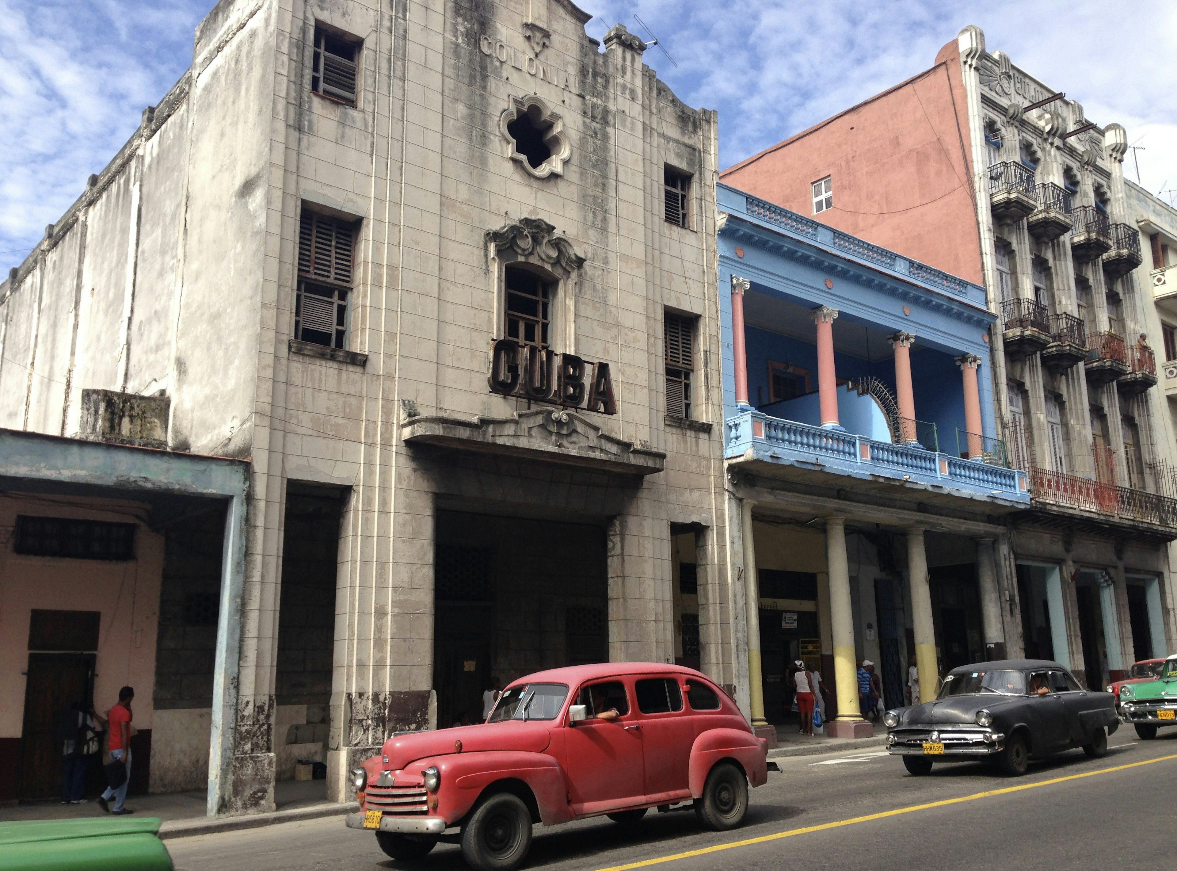 Old cars in street.