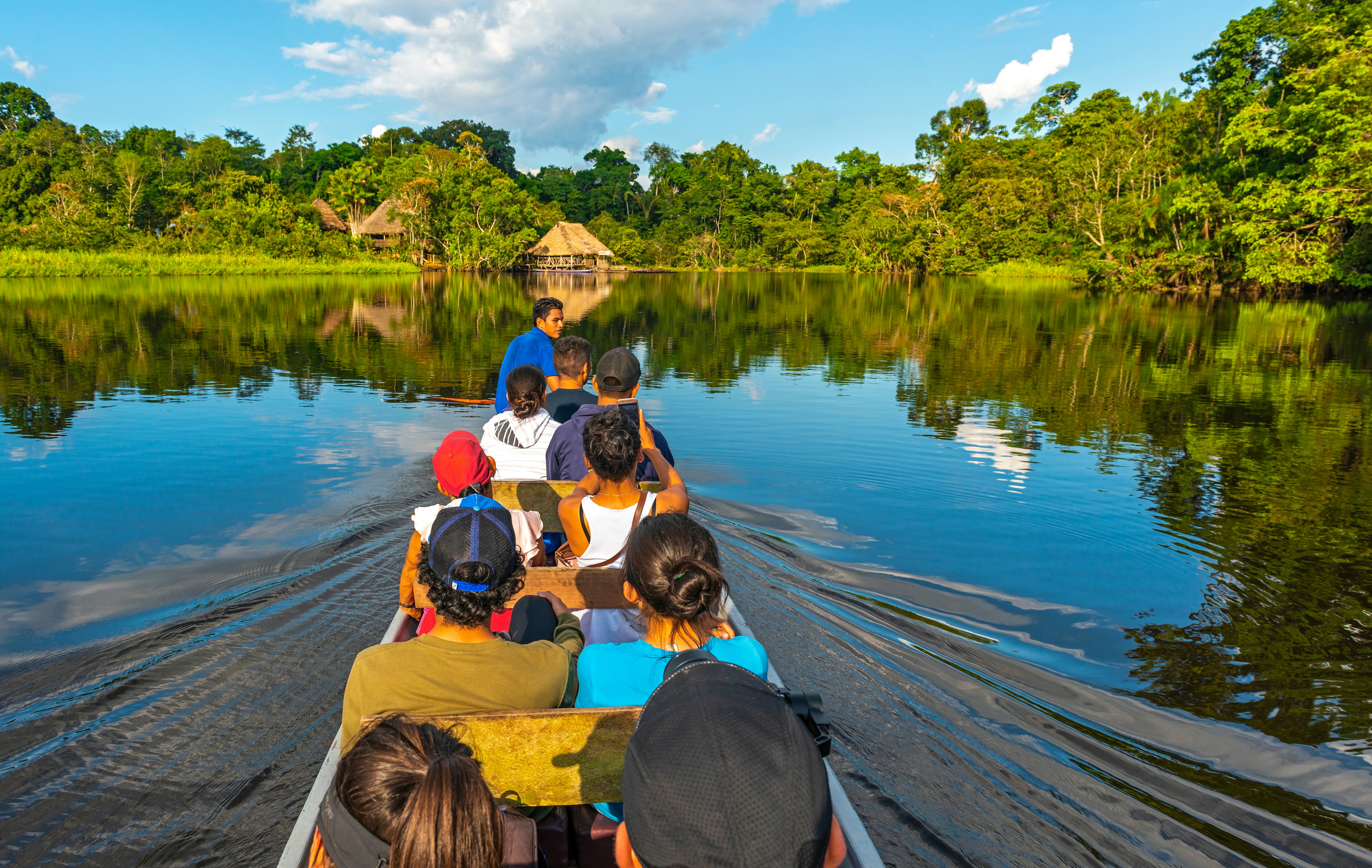 Tourists in a canoe on the Amazon River in Yasuni National Park, Ecuador.