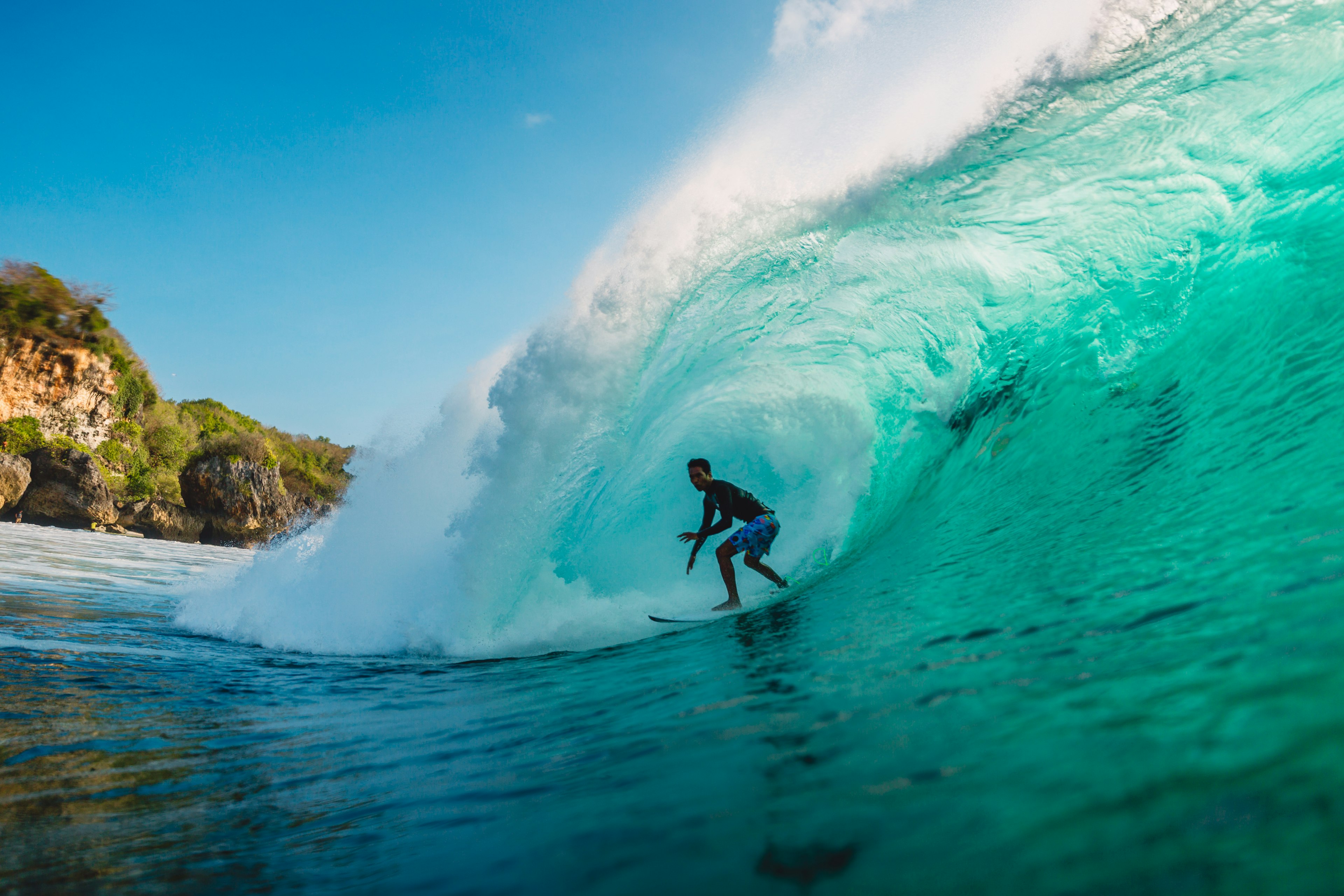 Bali, Indonesia. Surfer ride on barrel wave.