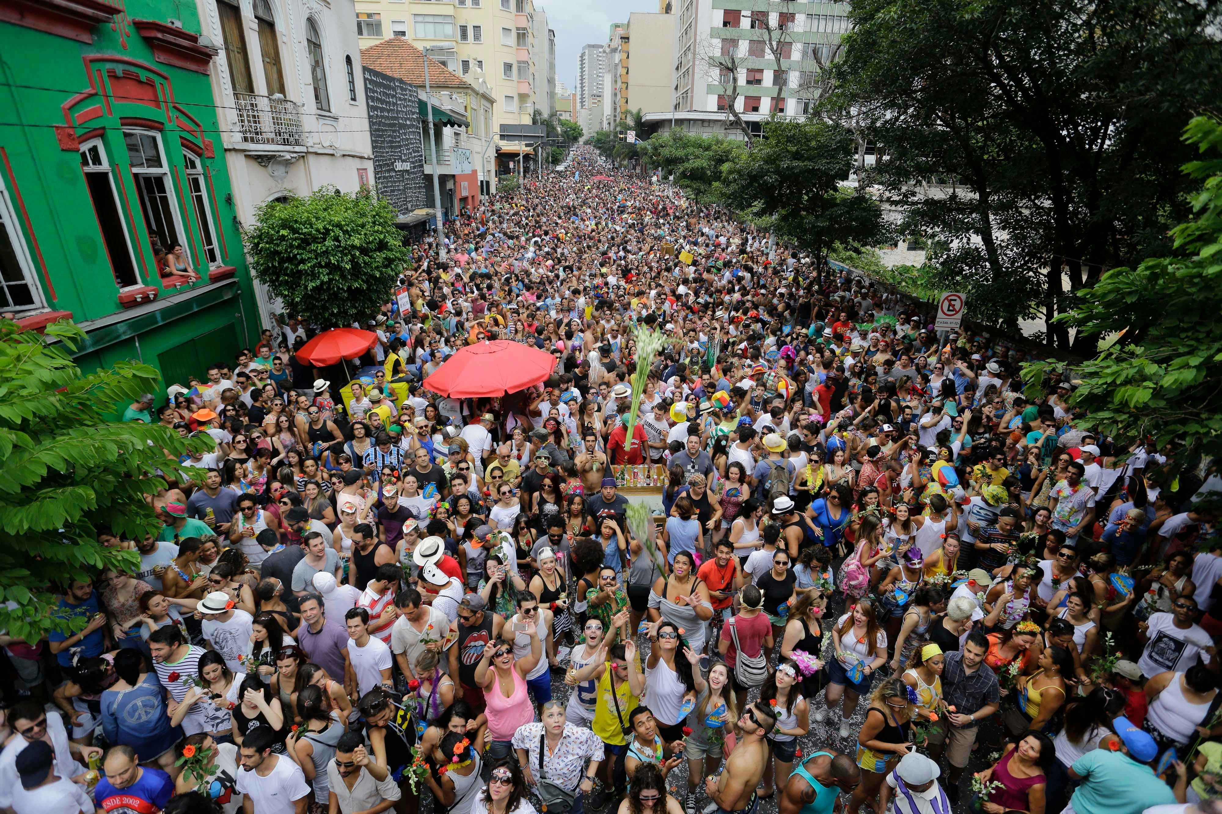 A big crowd sing and dance during a bloco carnival parade in Augusta street, downtown São Paulo.