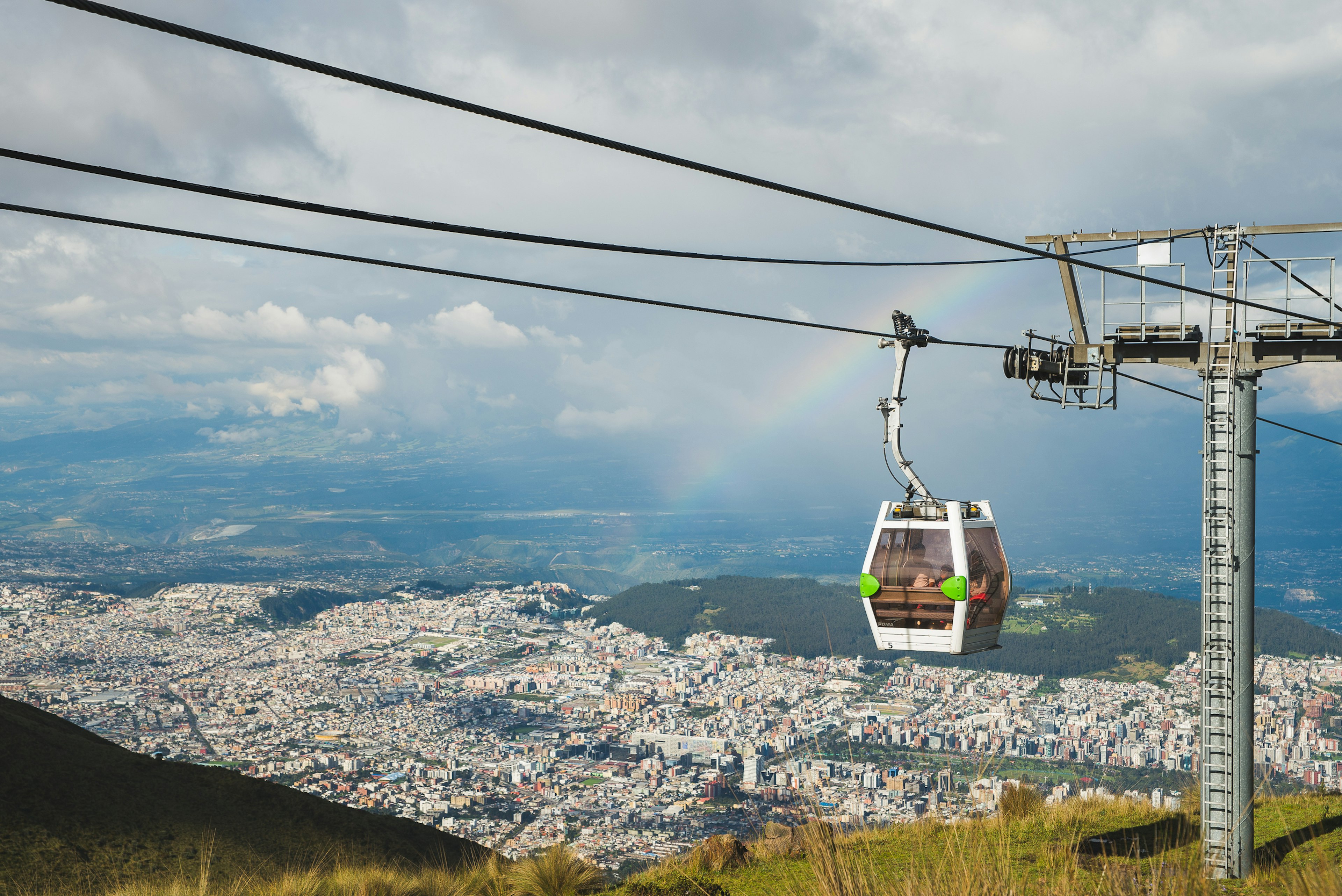 A cable car travels high above a city