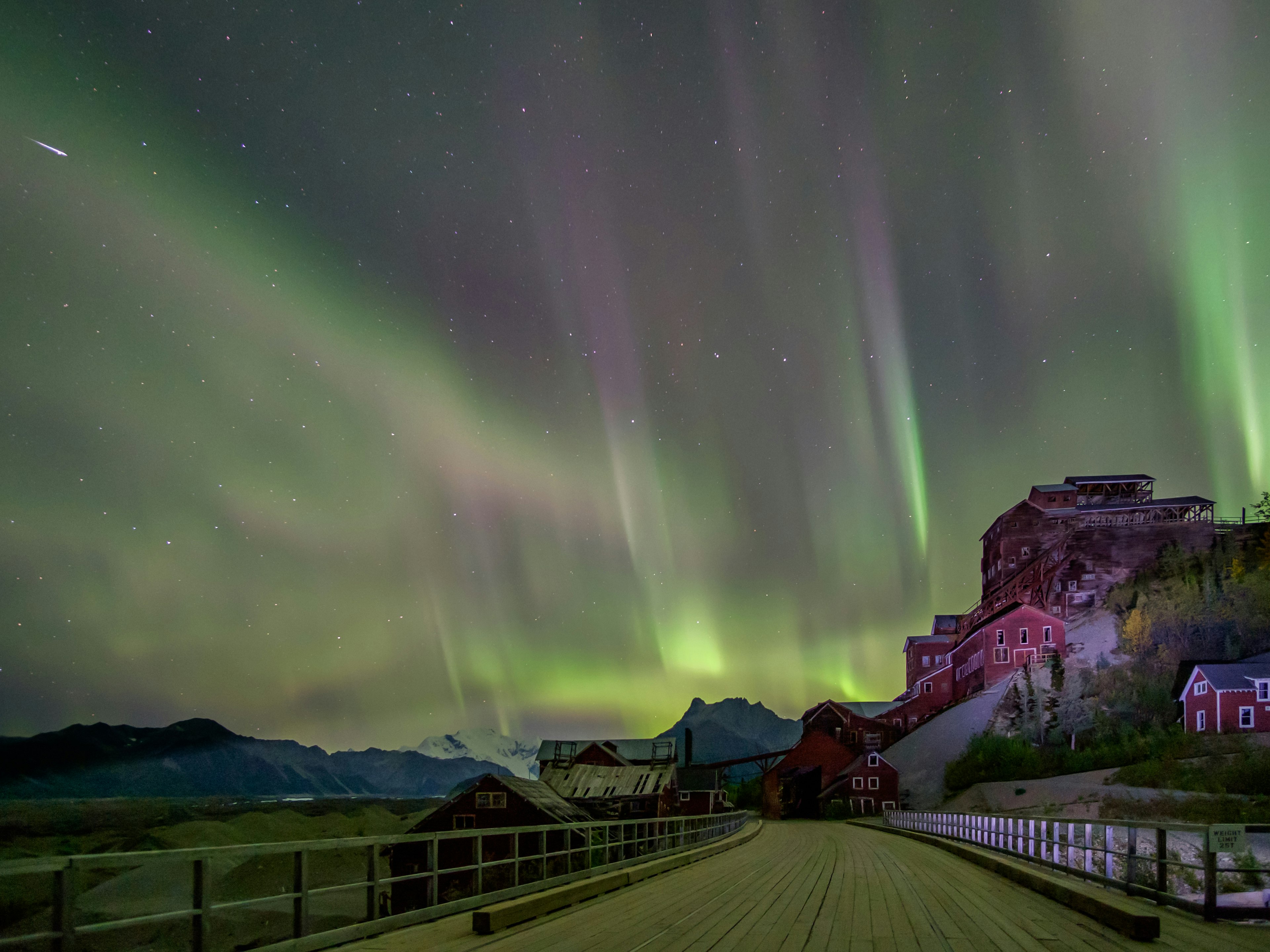 The northern lights shine over Kennicott Mill building in St Elias National Park in Alaska.