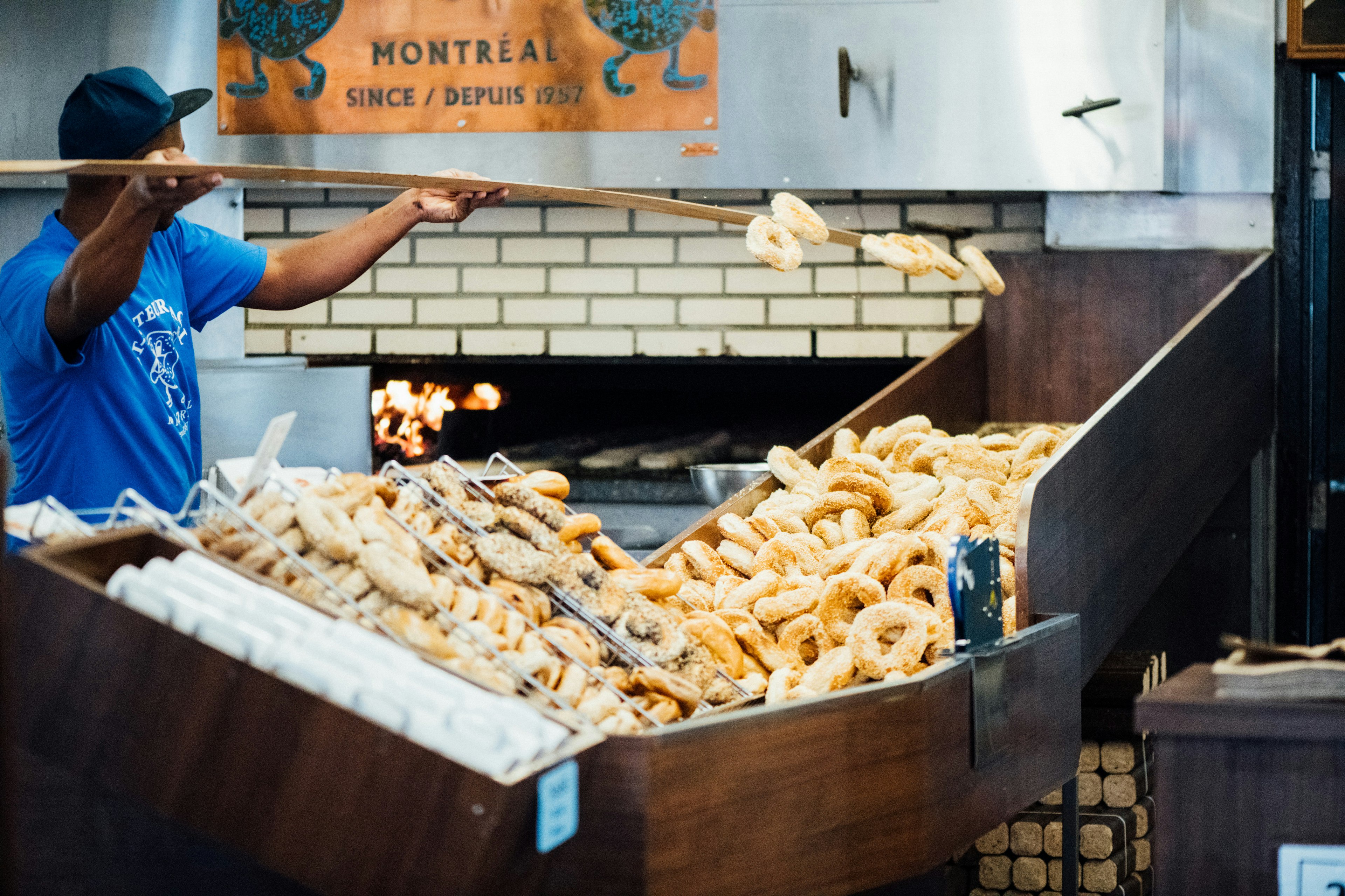 A man tossing bagels at St Viateur bakery in Montréal, Canada