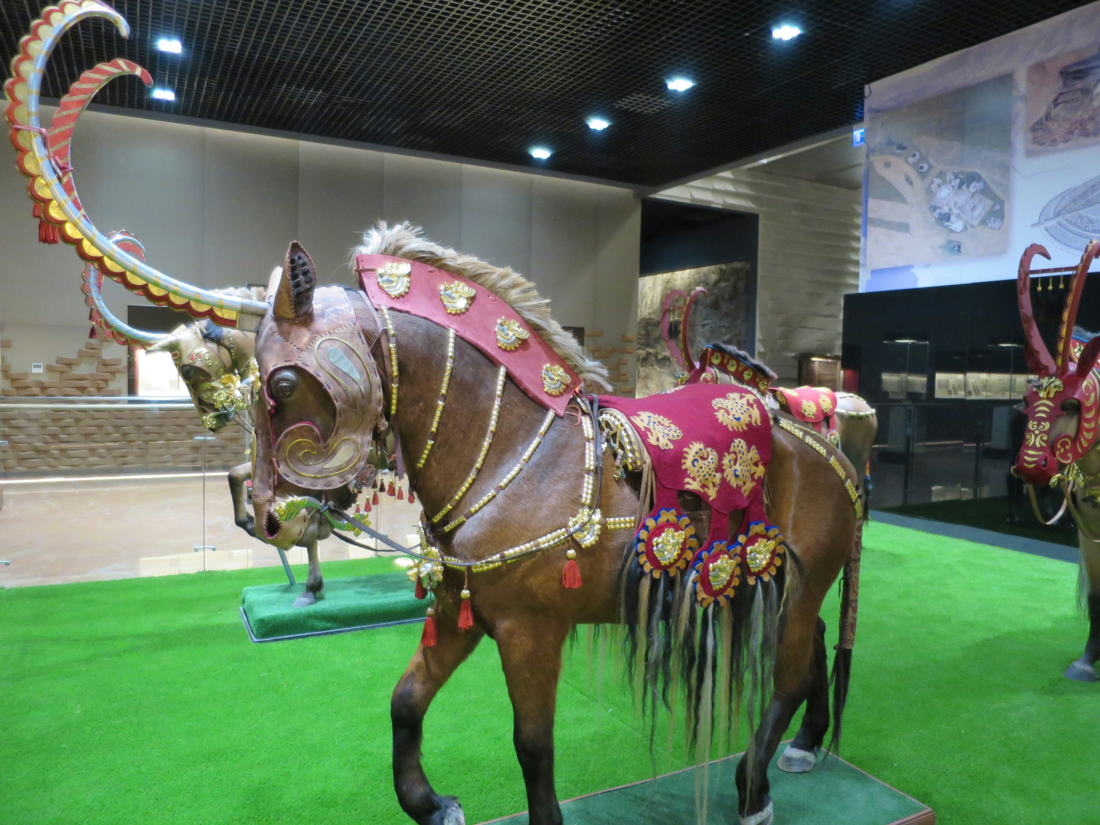 Interior of National Museum of the Republic of Kazakhstan, horses showing traditional Kazakh armour and saddles