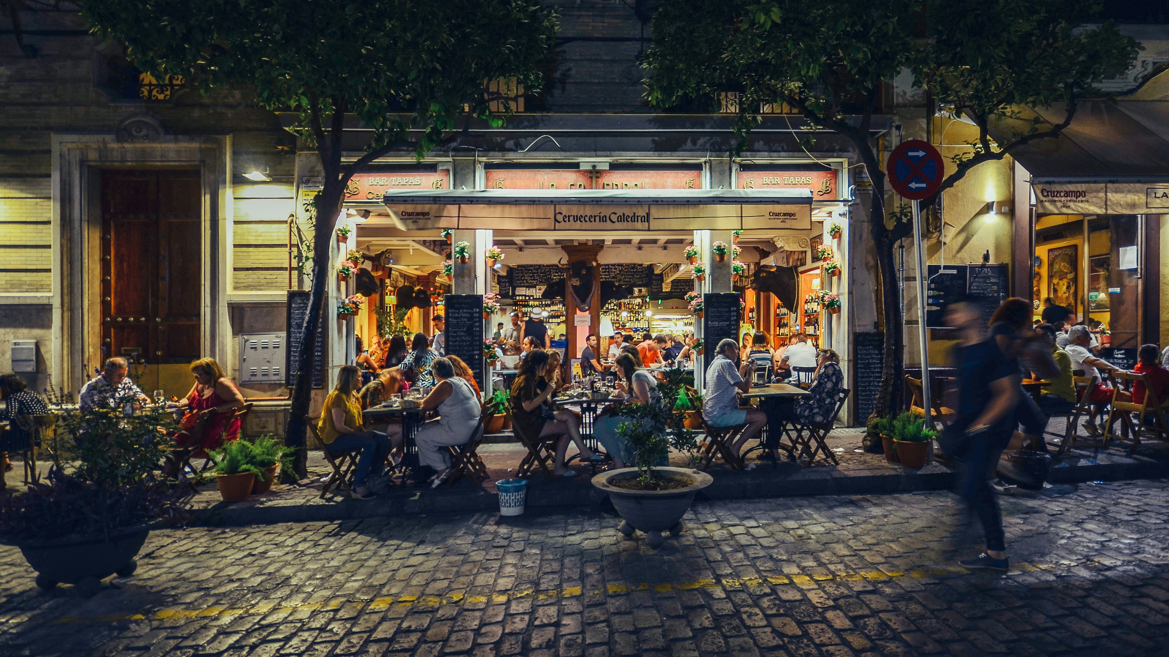 Busy bar and restaurant on Calle Mateos Gago servicing Spanish style tapas to locals and tourists well into the late hours in the historic center of Seville.