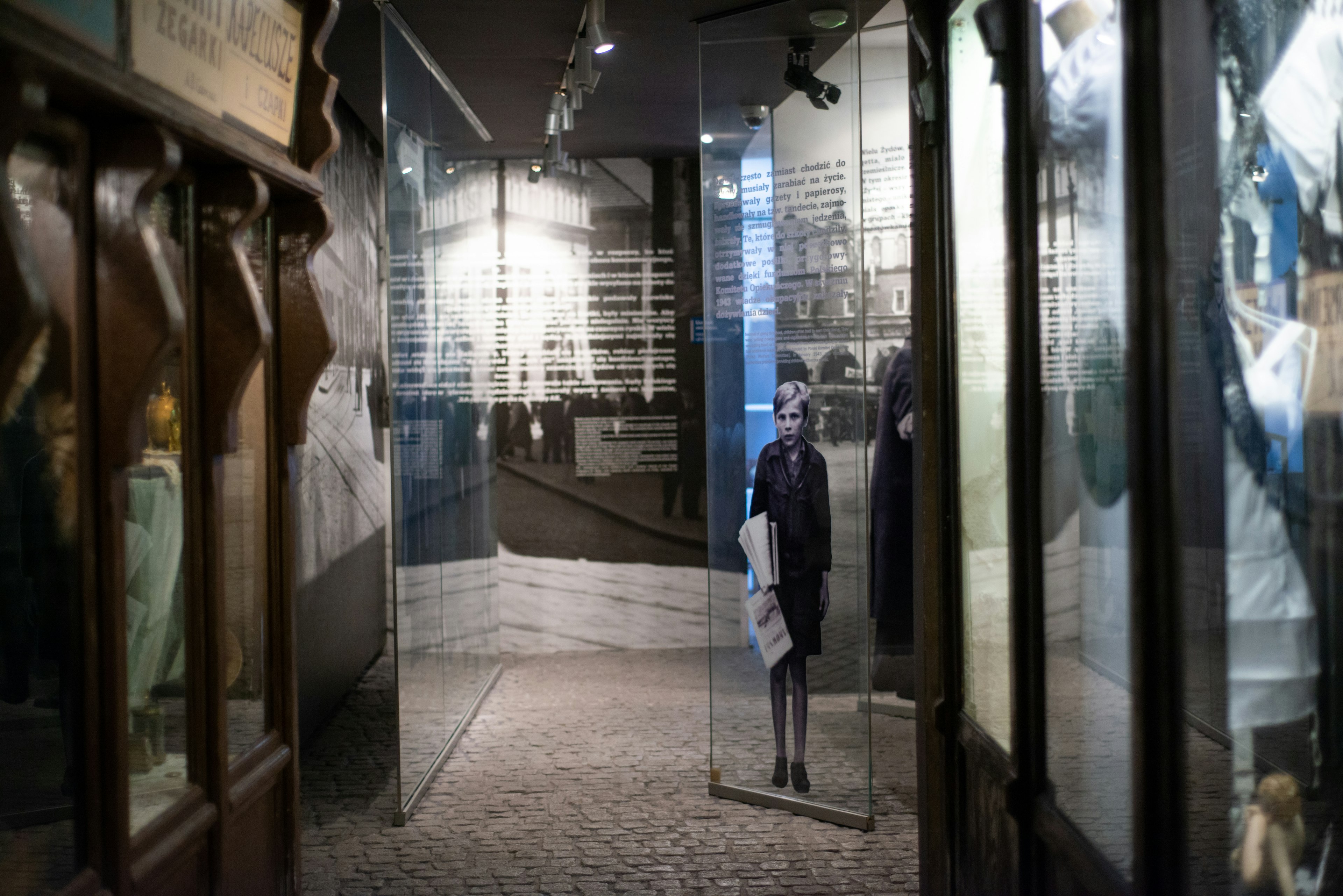 Exhibits including a black-and-white image of a girl inside the Schindler’s Factory museum in Kraków, Poland