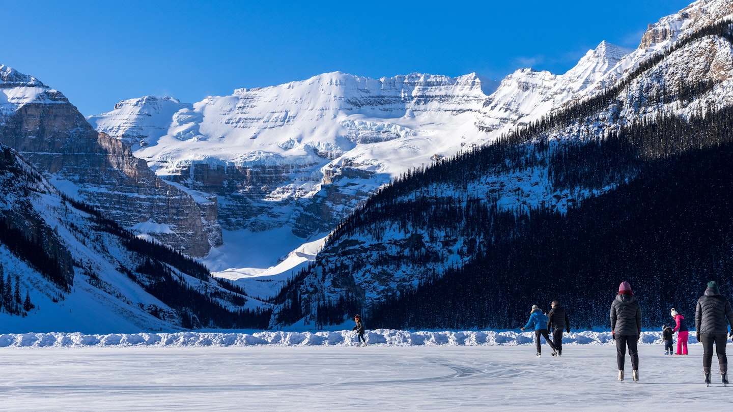 Tourists skating on Lake Louise winter ice skating rink. Banff National Park, Canadian Rockies. Alberta, Canada., License Type: media, Download Time: 2024-08-23T16:48:26.000Z, User: joe_lp, Editorial: false, purchase_order: 56530, job: Global Publishing-Wip, client: Your Ultimate Travel Adventure List, other: Joe Fullman