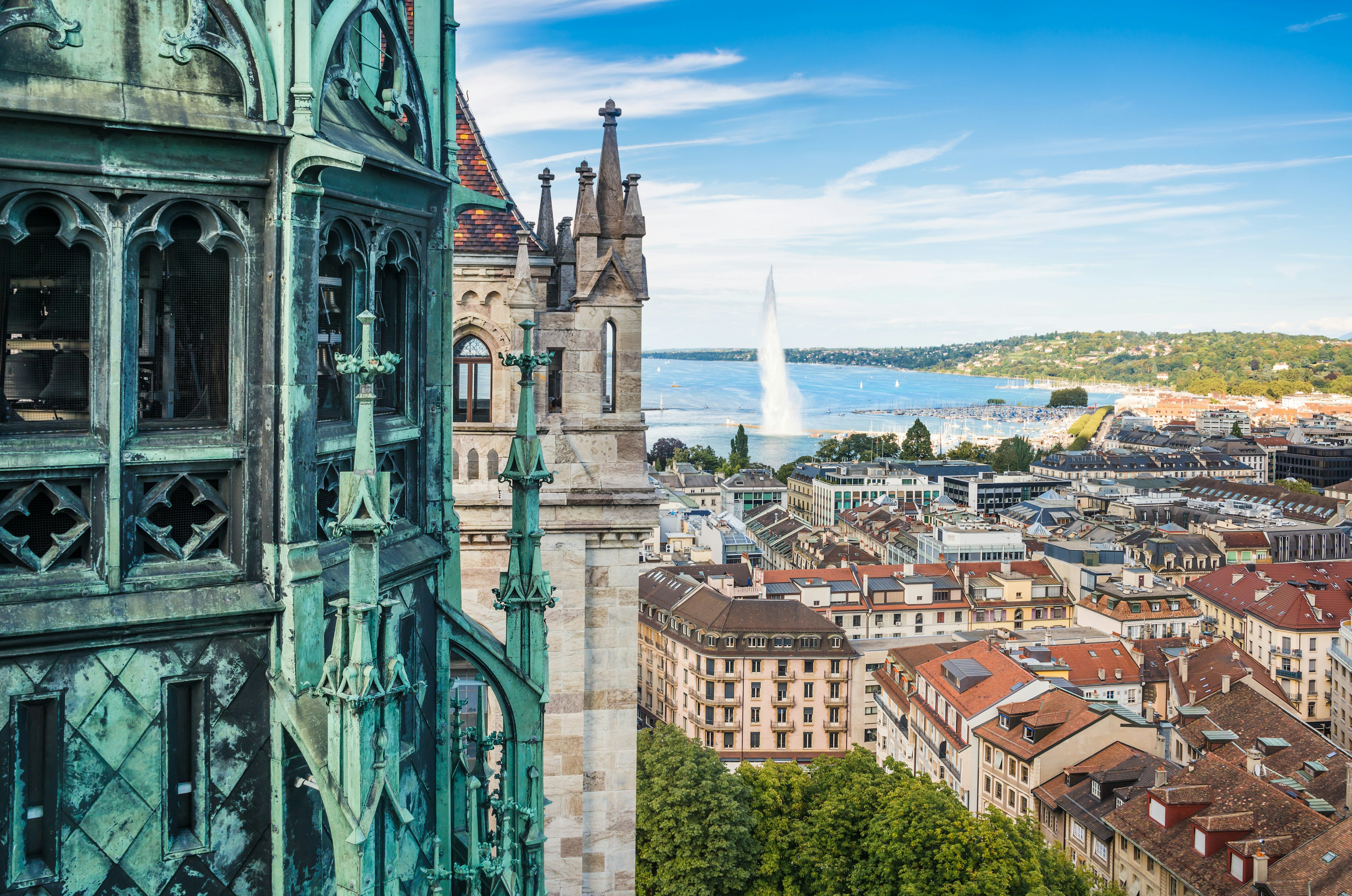 The view from a Gothic cathedral tower overlooking a lakeside city