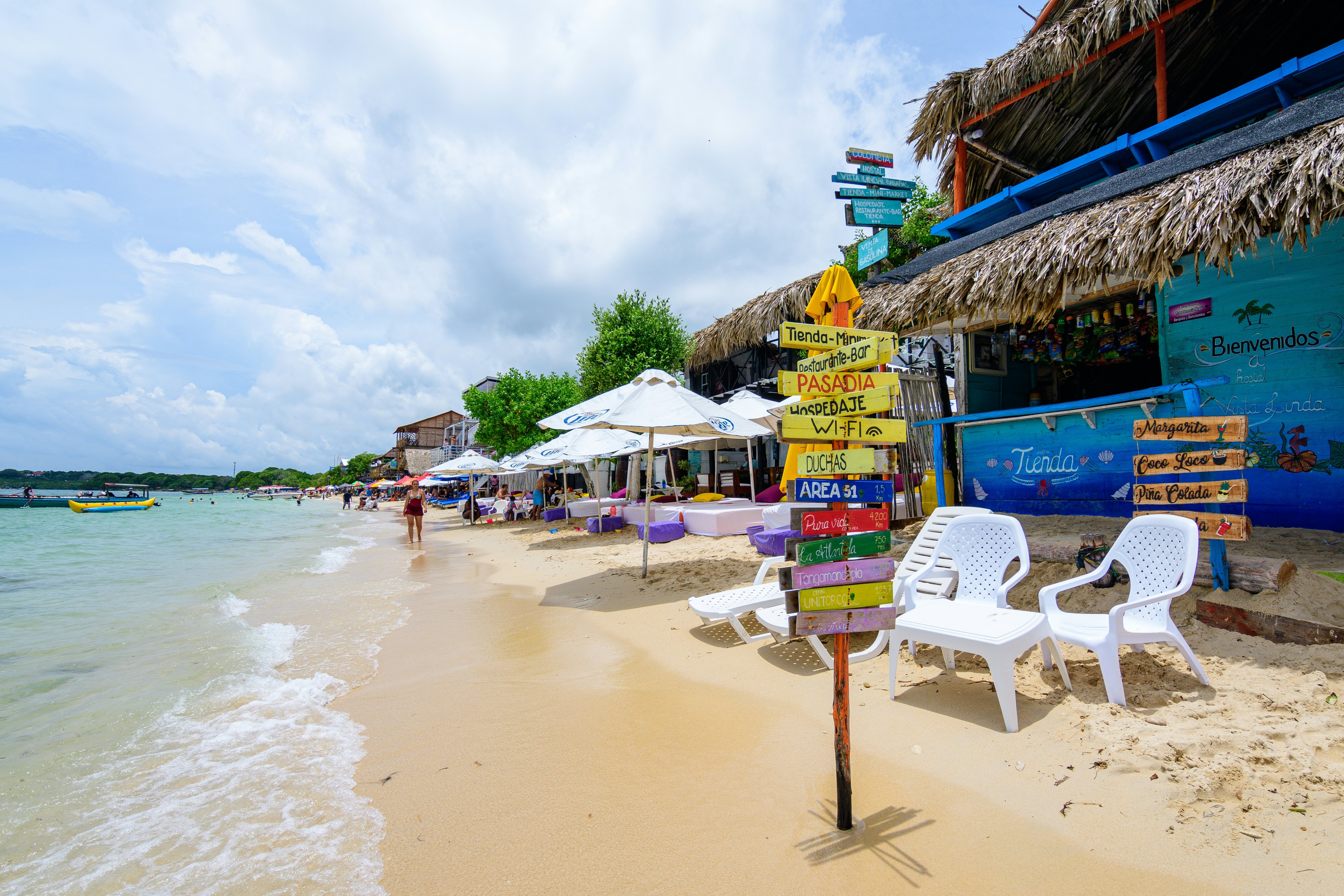 A string of huts and beach chairs along the beach on Isla Barú in Cartagena, Colombia