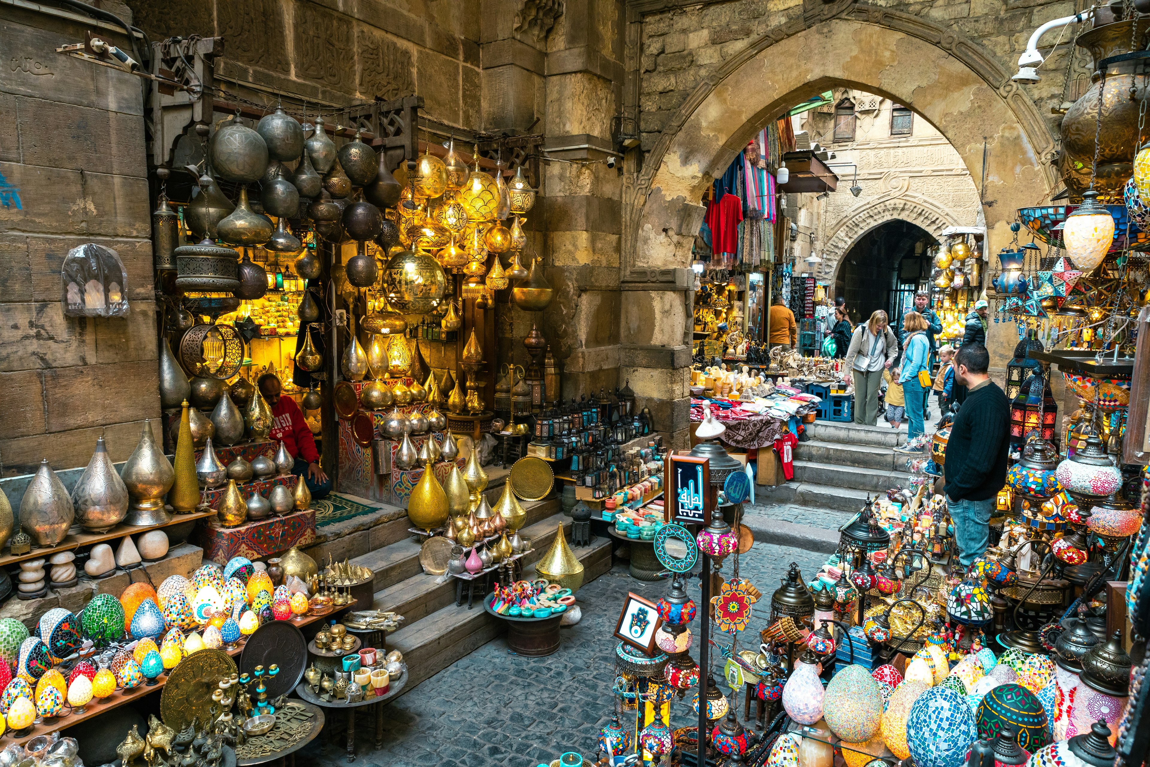 An alleyway in a bazaar lined with lanterns and lamps for sale