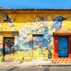 Cartagena, Colombia - 22 March 2023: Graffiti mural of a bird on a house on Holy Trinity square (Plaza Trinidad) in the Getsemani neighborhood of Cartagena, Colombia., License Type: media, Download Time: 2024-11-18T14:51:44.000Z, User: tasminwaby56, Editorial: true, purchase_order: 65050 - Digital Destinations and Articles, job: Online Editorial, client: Cartagena Best TTD, other: Tasmin Waby
