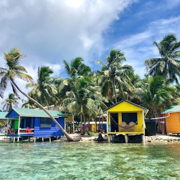 Tobacco Caye, Belize - June 16, 2018: Overwater budget cabanas on the tiny island of Tobacco Caye on Belize's barrier reef. , License Type: media_digital, Download Time: 2024-11-10T17:06:28.000Z, User: bhealy950, Editorial: true, purchase_order: 65050 - Digital Destinations and Articles, job: Lonely Planet Online Editorial, client: Caribbean Christmas desinations, other: Brian Healy