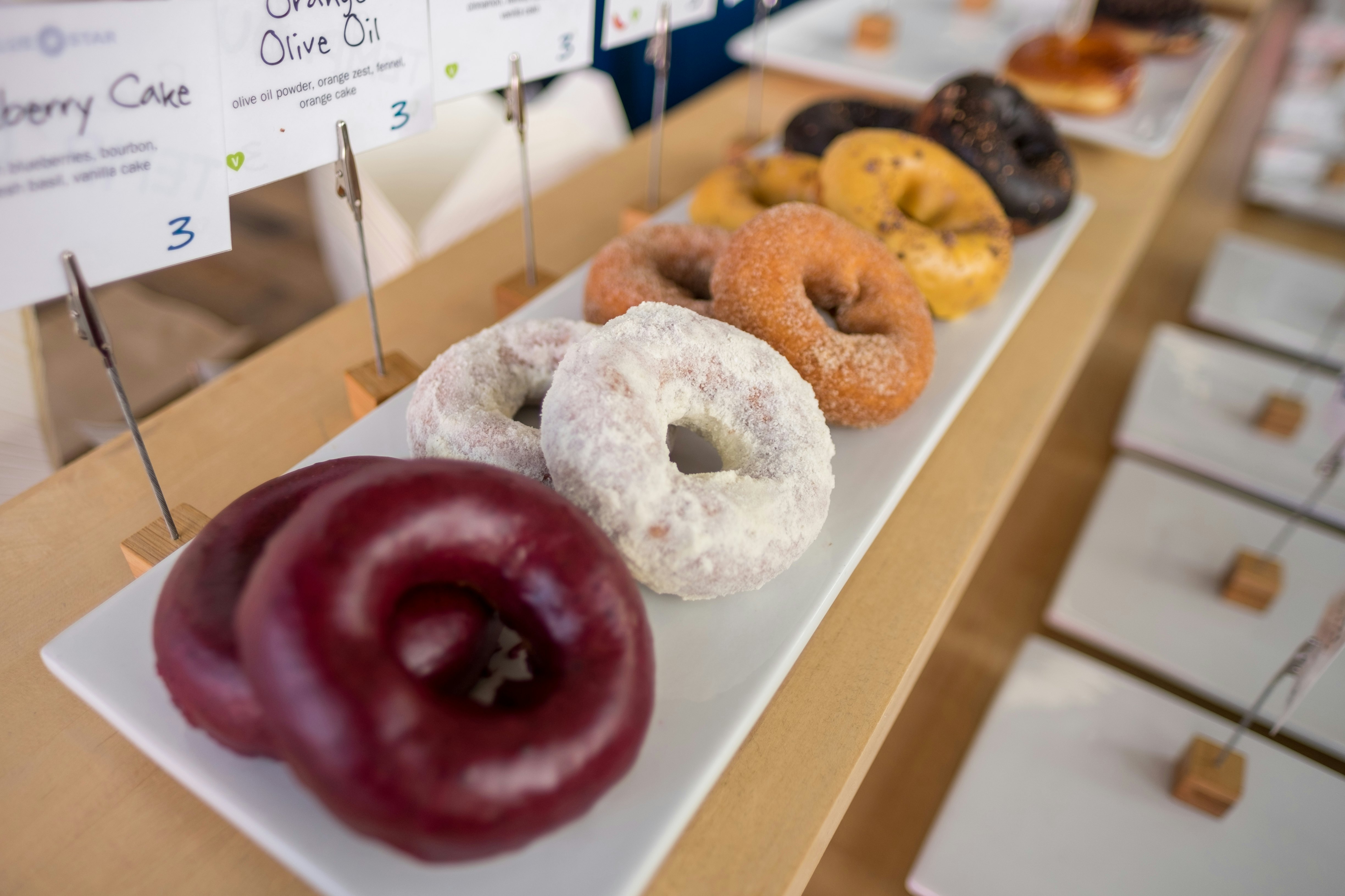 Colorful donuts are on display for sale at Blue Star Donut, Portland, Oregon, USA