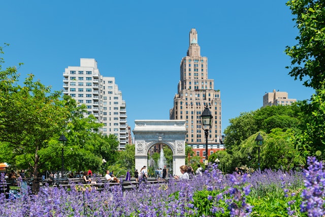 Washington Square Park in Manhattan with the iconic landmark arch and visitors enjoying a sunny spring morning
