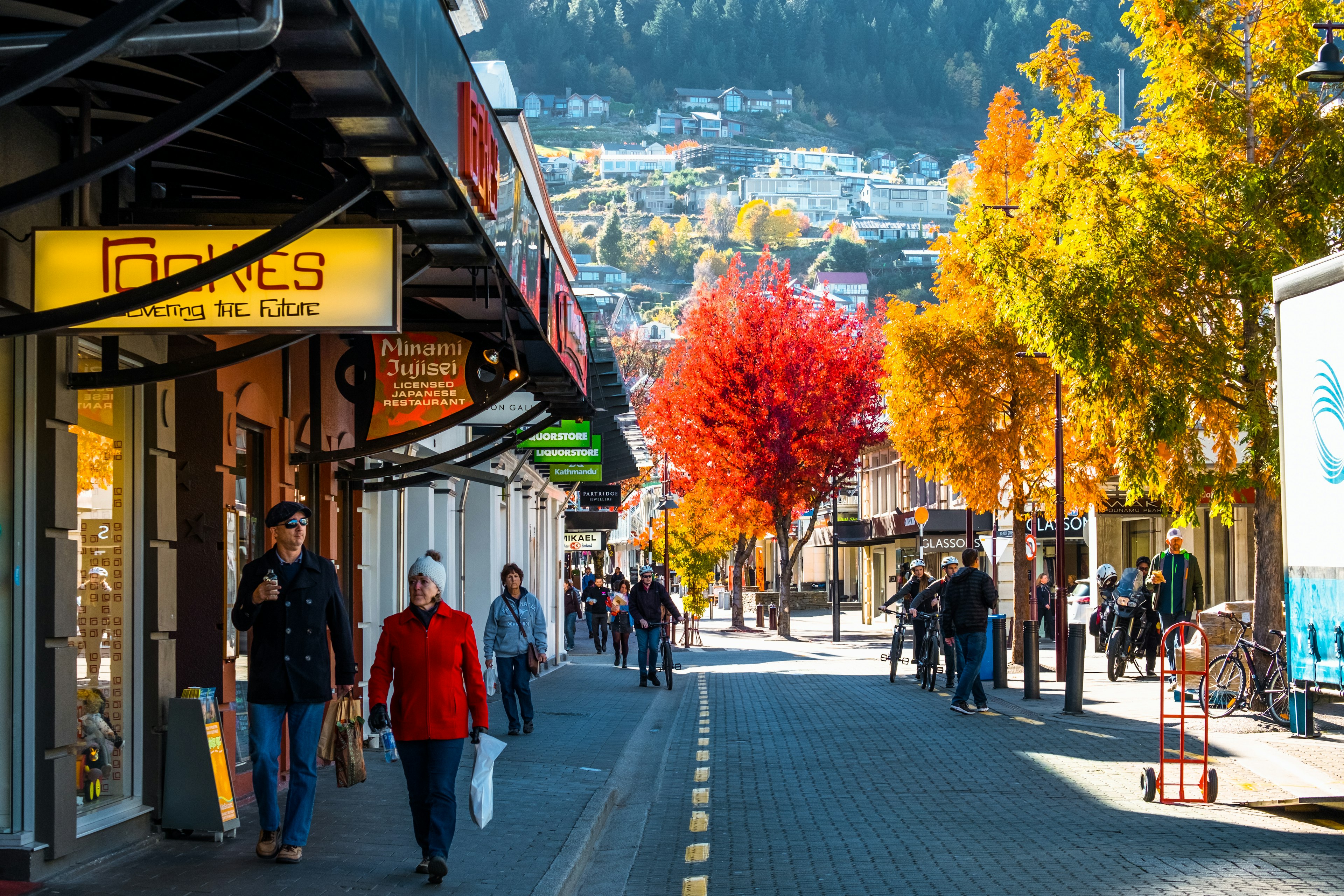 Queenstown, New Zealand, People and the town after sunset.