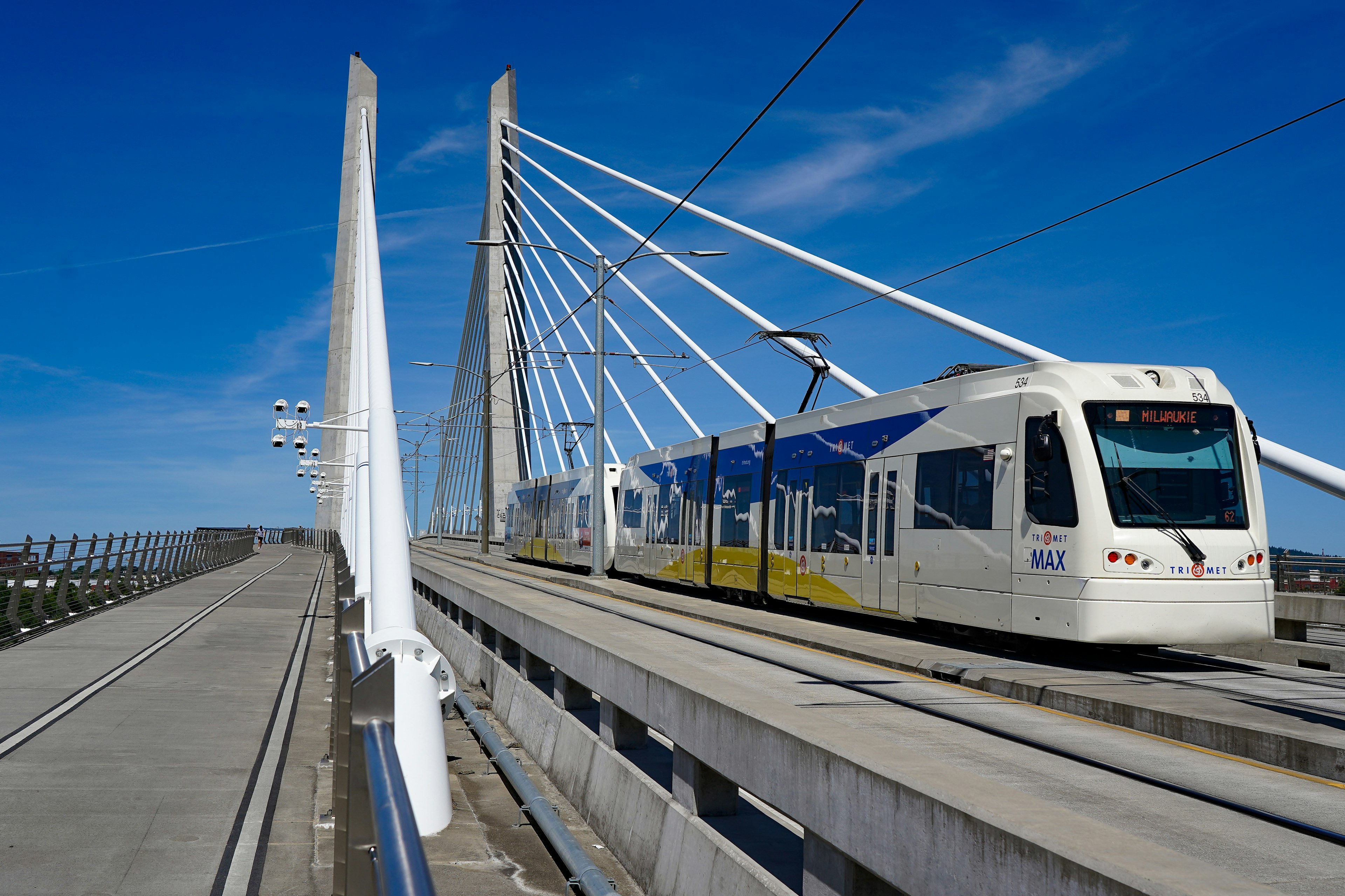 The MAX light rail train on the Tilikum Bridge over the Willamette River.