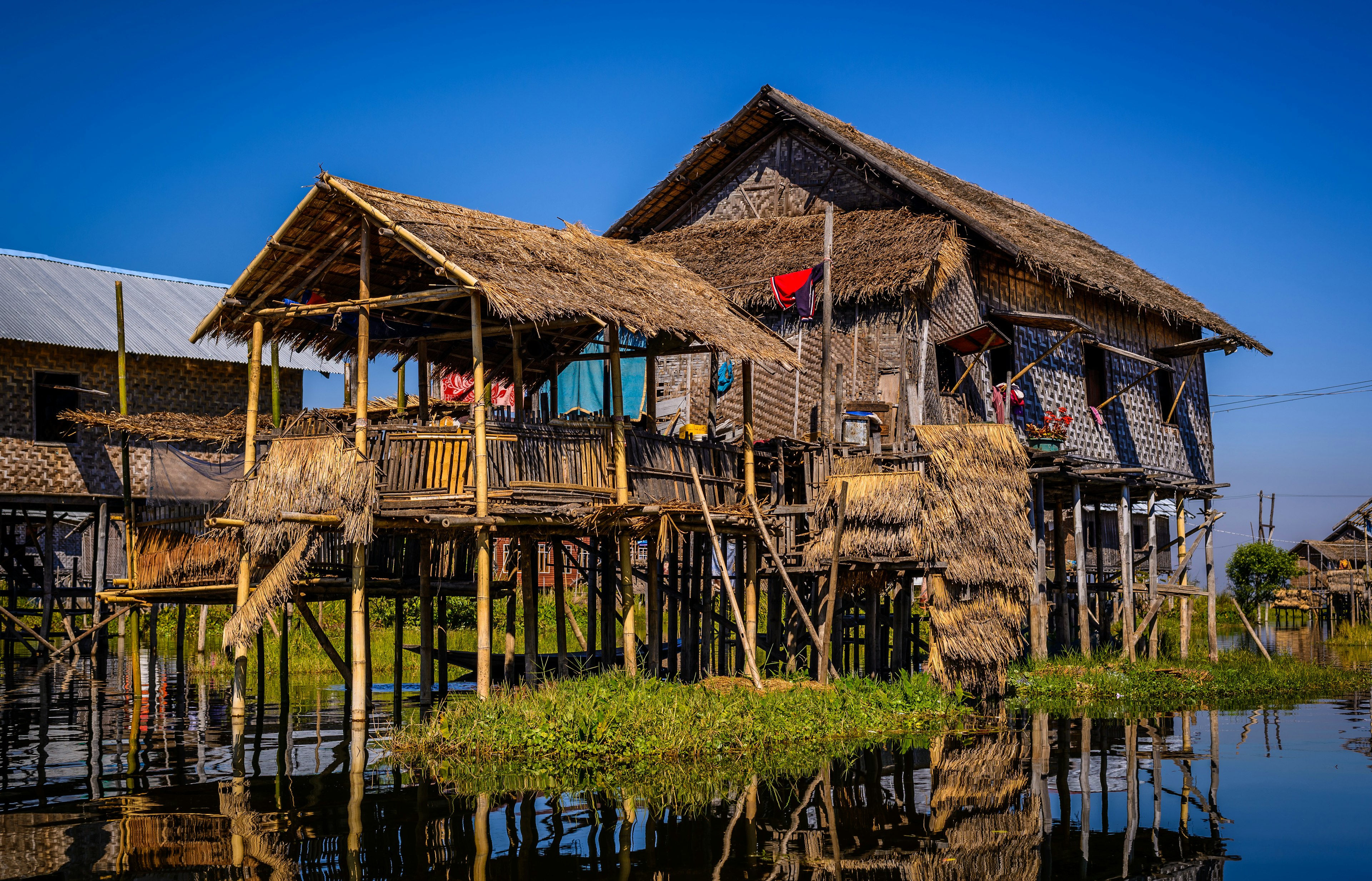 Bamboo-pole stilt house on the water at Inle Lake.