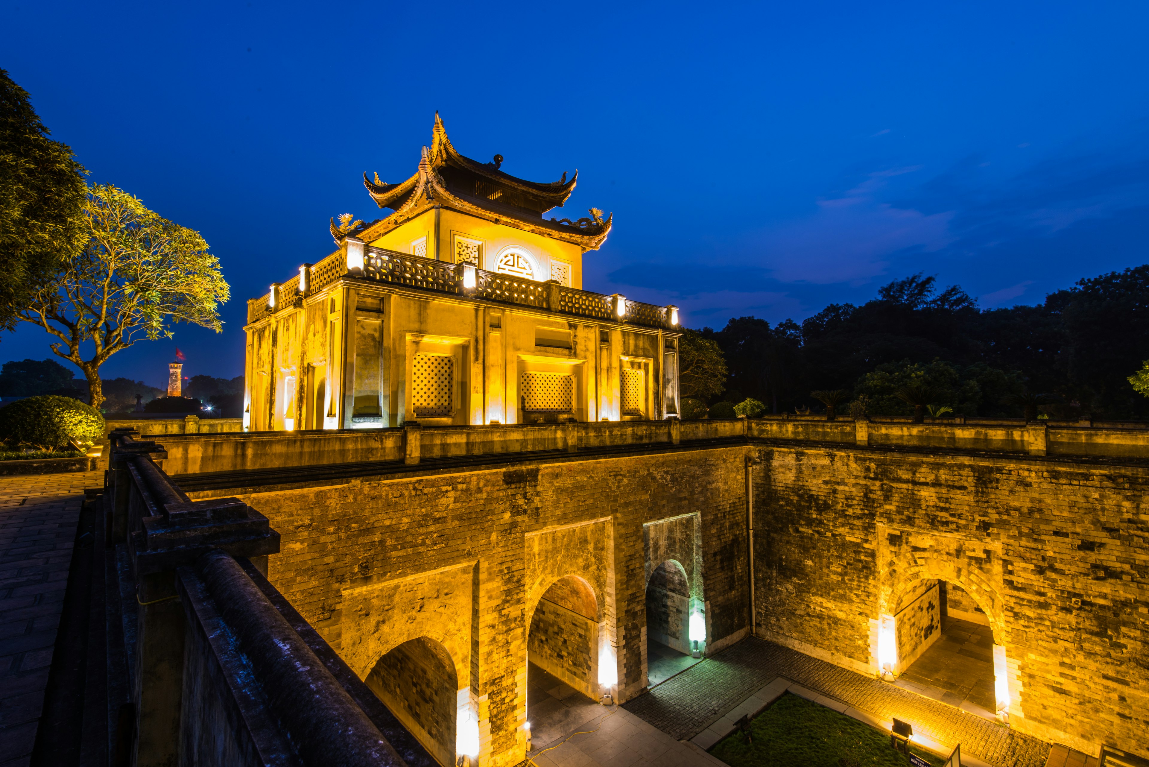 Dramatic light illuminates the heavy stone ramparts of Thang Long Imperial Citadel at night, Hanoi, Vietnam