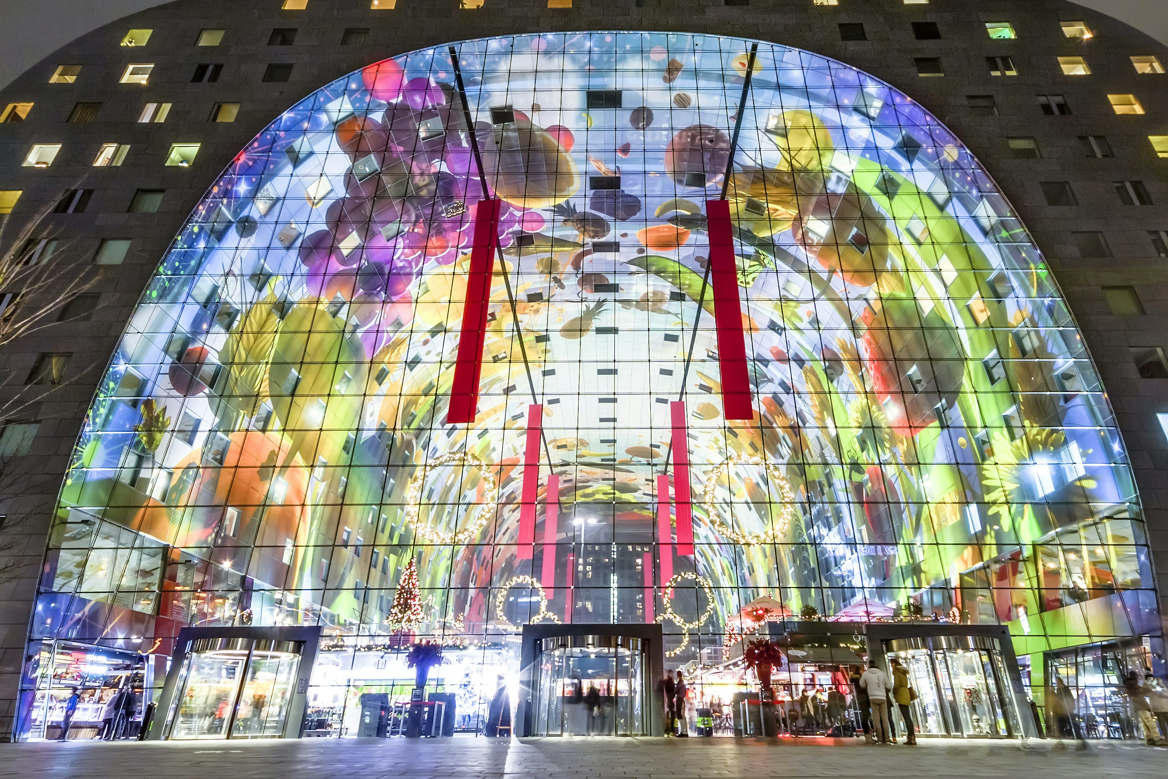 An exterior view of Rotterdam's Markthal lit up at night