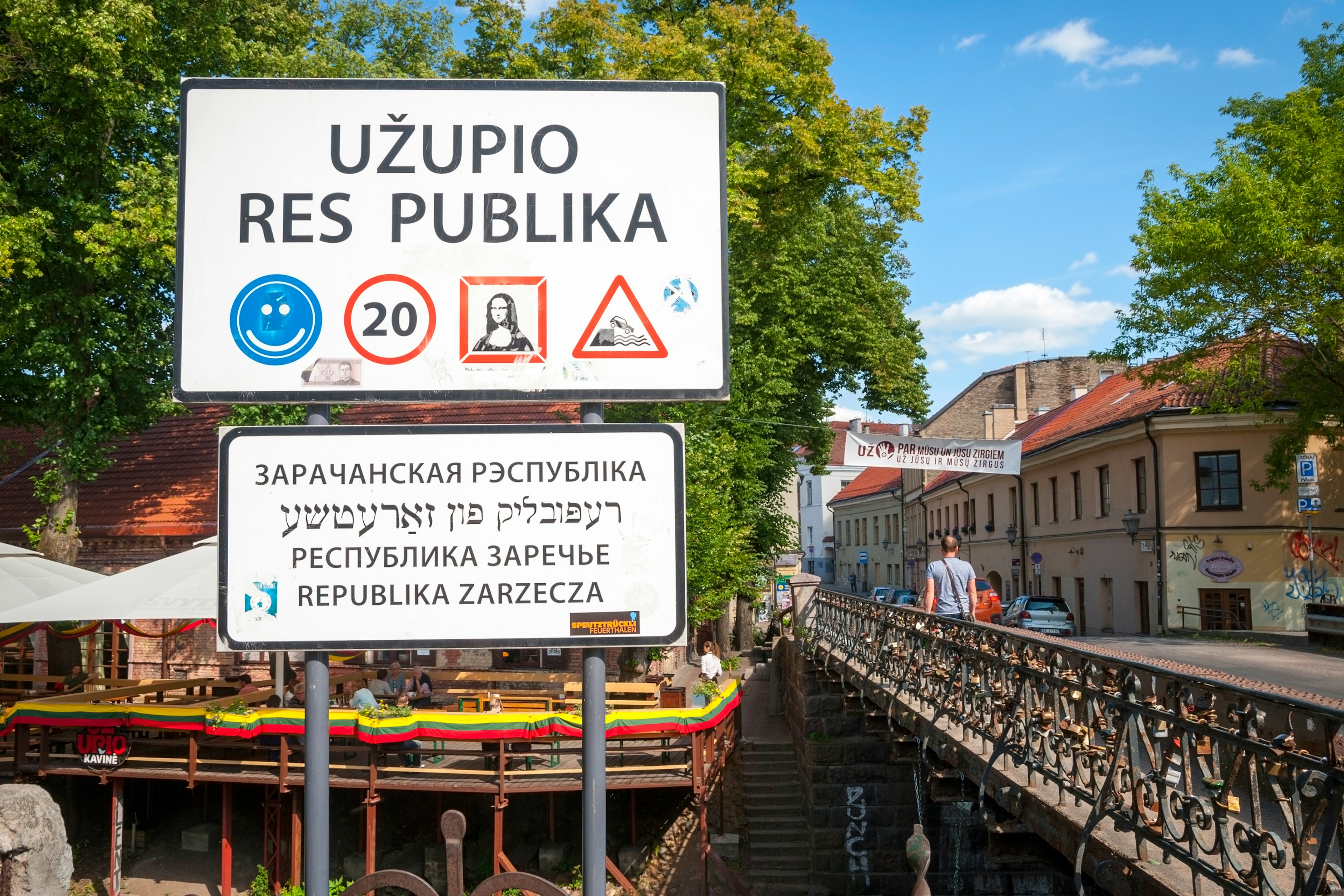 A large sign before a bridge marks the border of the Užupio Republic