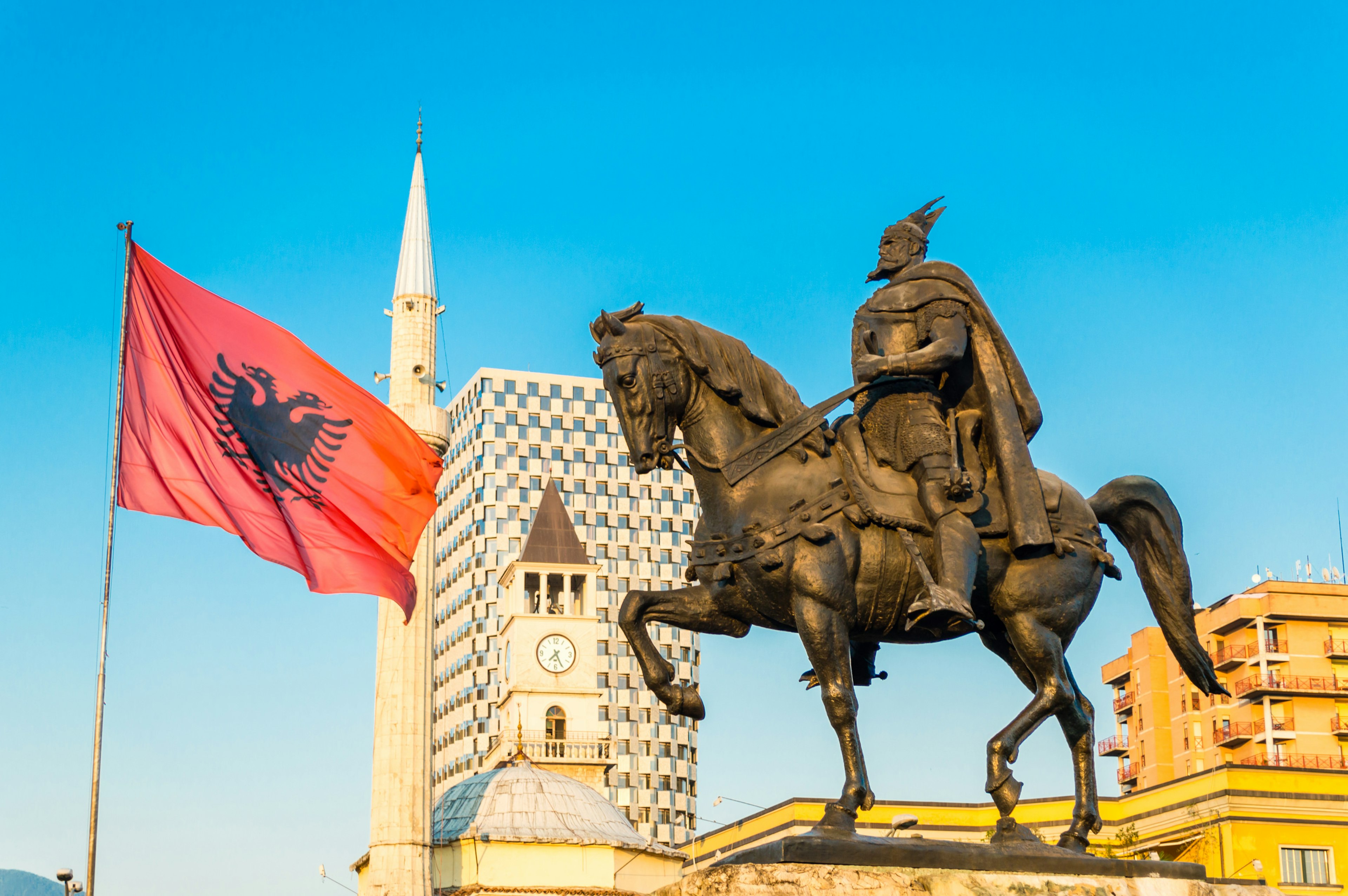 Skanderbeg square with flag and monument, and The Et'hem Bey Mosque, in the center of Tirana city, Albania.