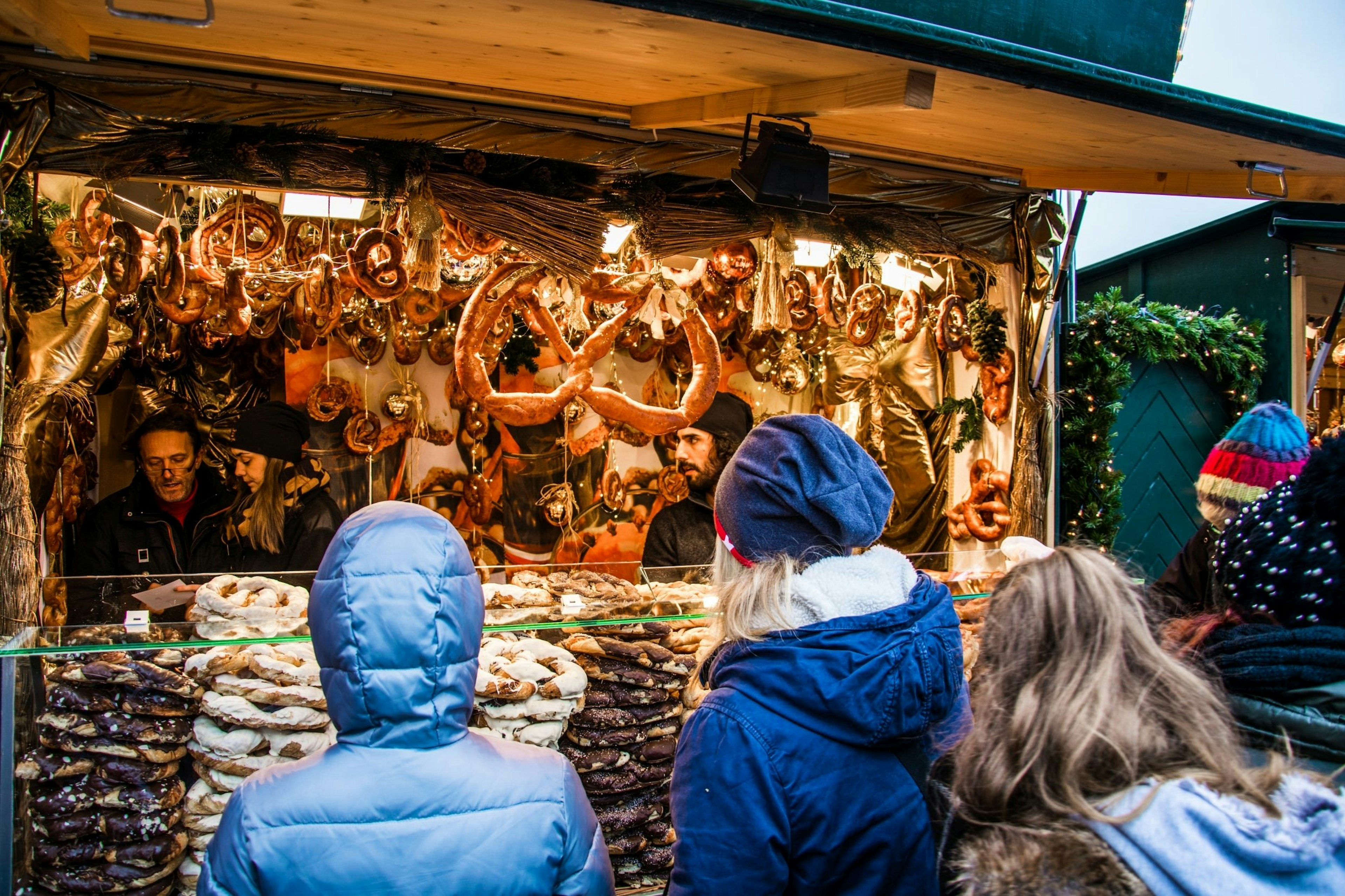 People line up at a food stall during a Christmas market in front of the Schonbrunn Castle in Vienna.