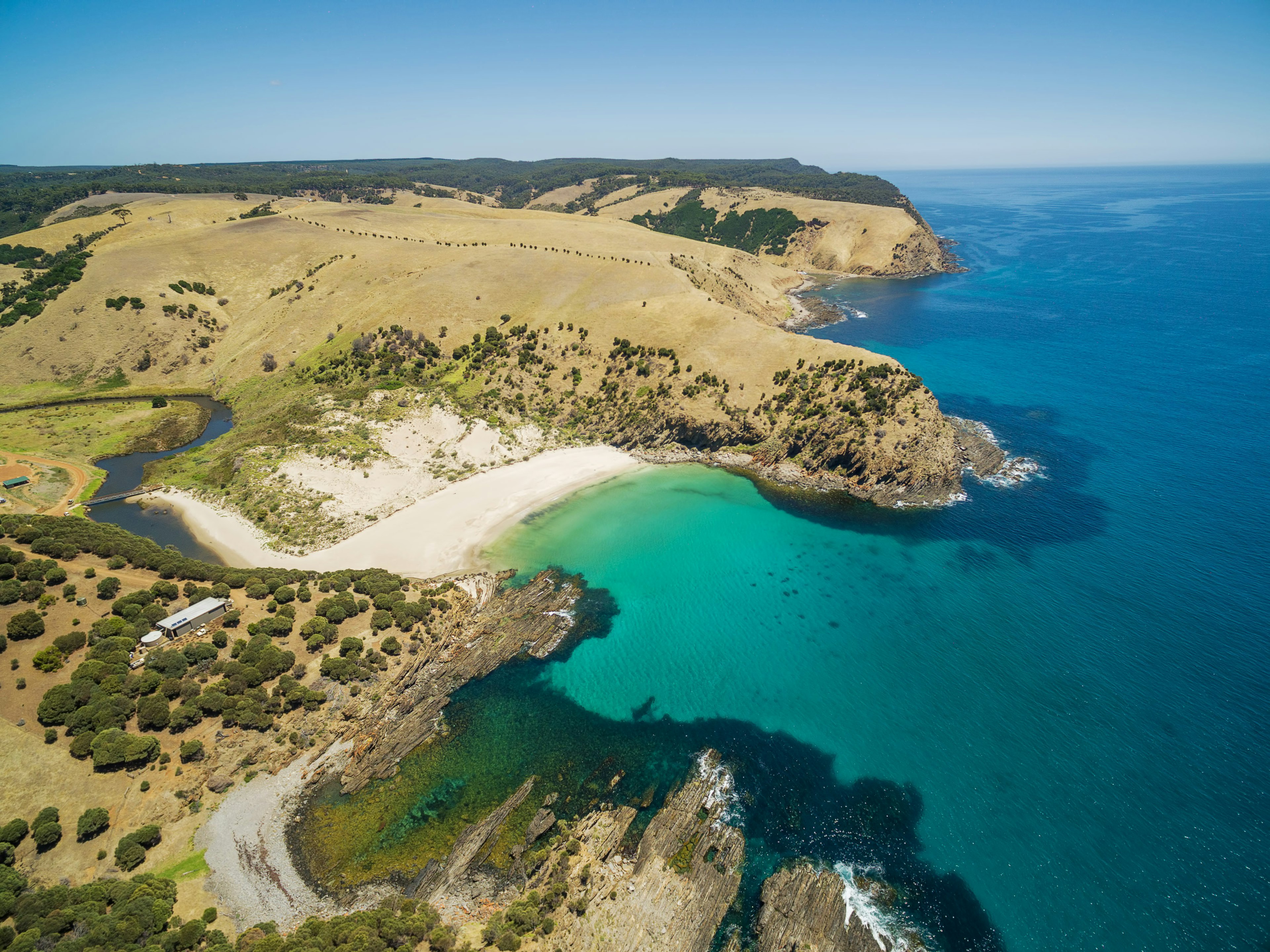 From above: a river twisting to Snelling Beach and the turquoise ocean water at Kangaroo Island, South Australia.