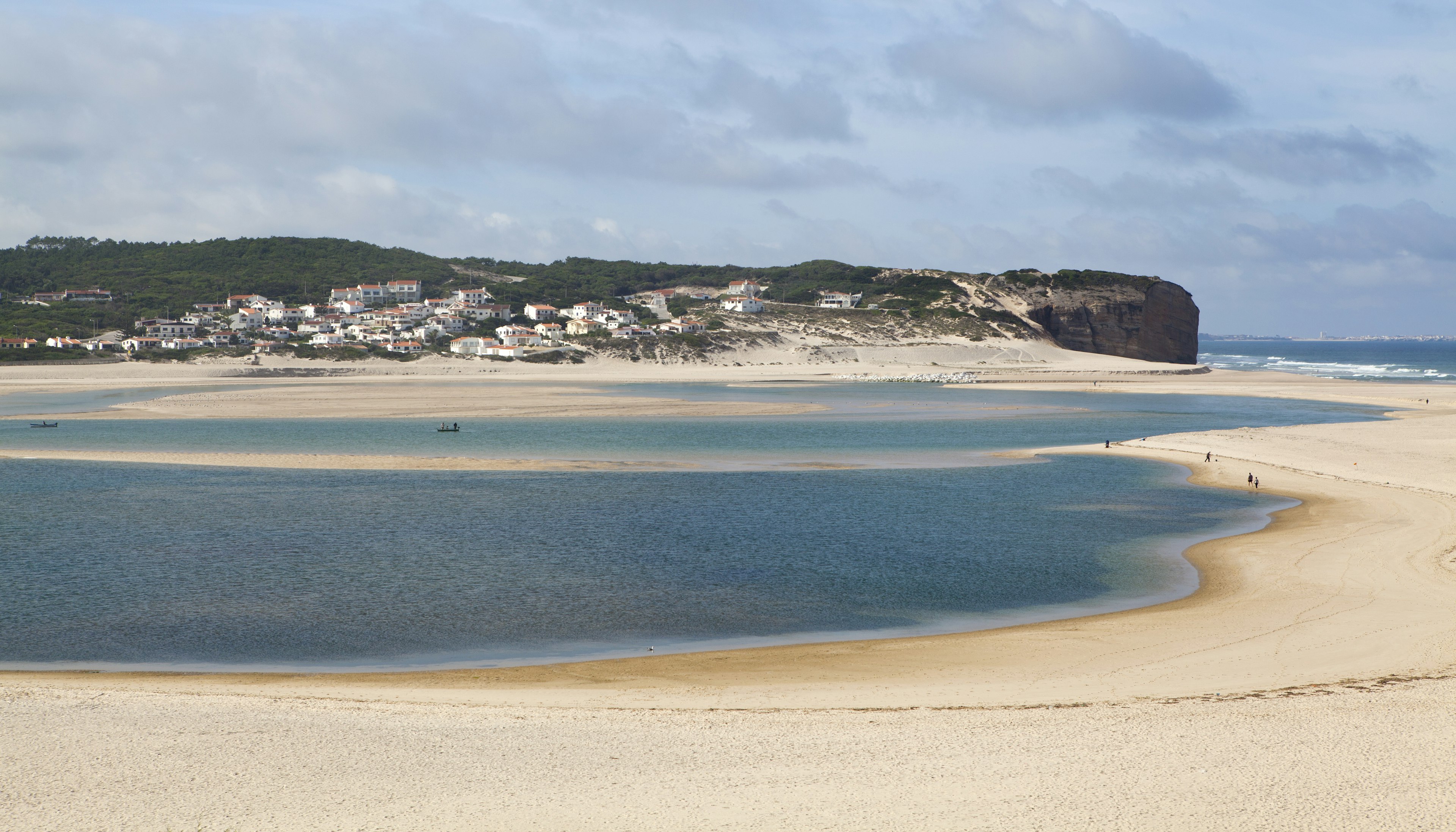 A lagoon surrounded by beach near a headland