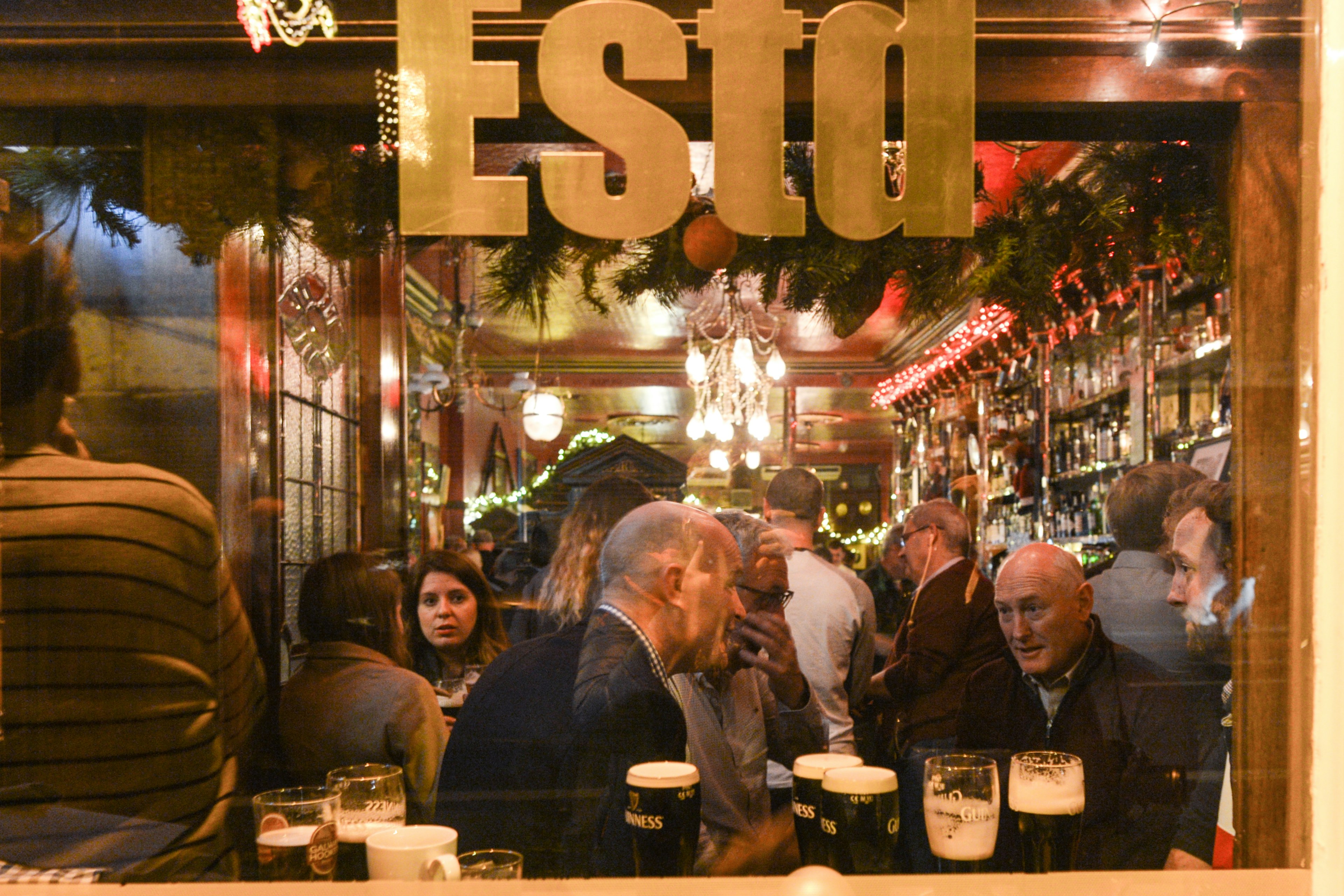 People enjoy a drink and chat in The Long Hall pub in Dublin