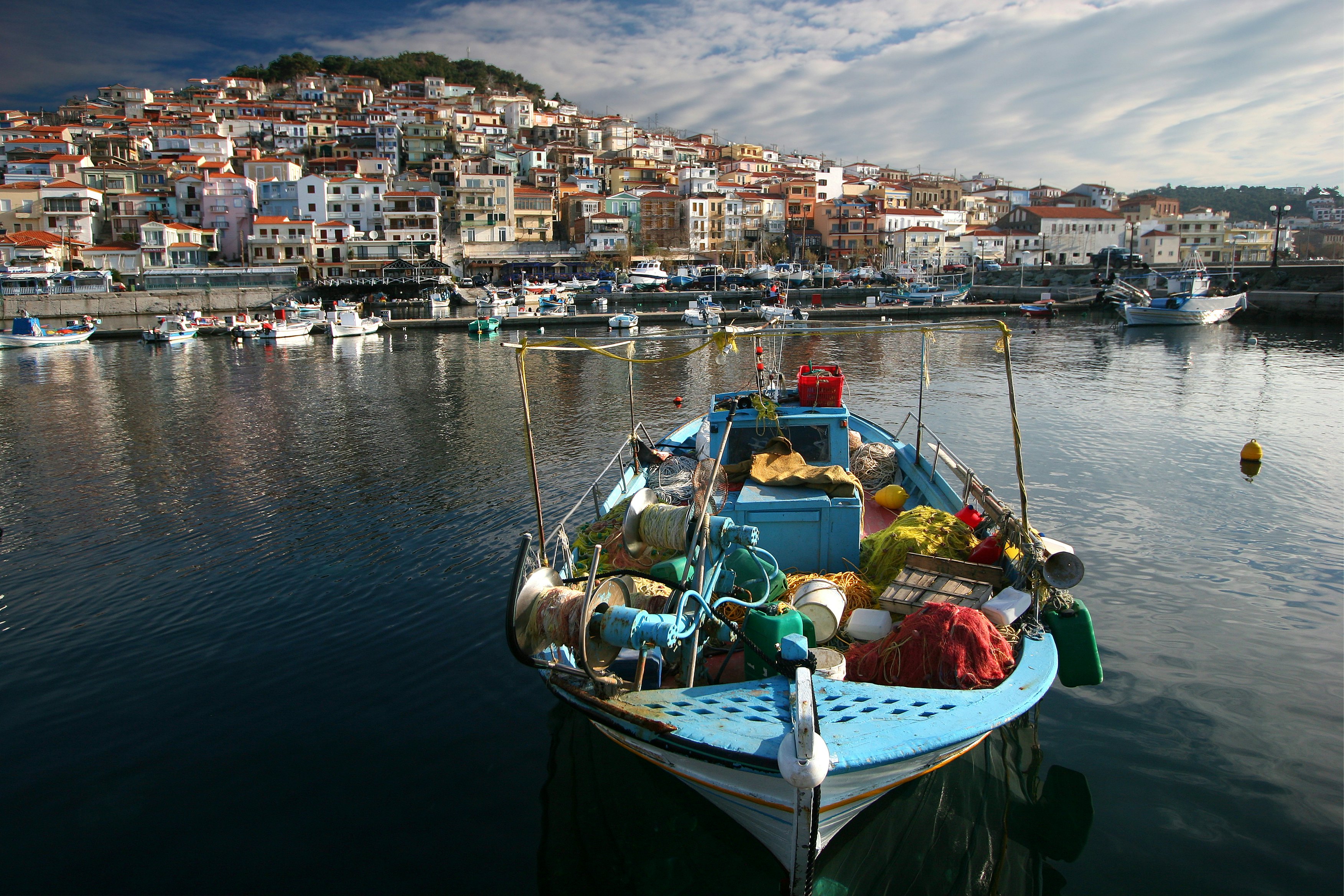 Fishing boat laden with nets in harbour.