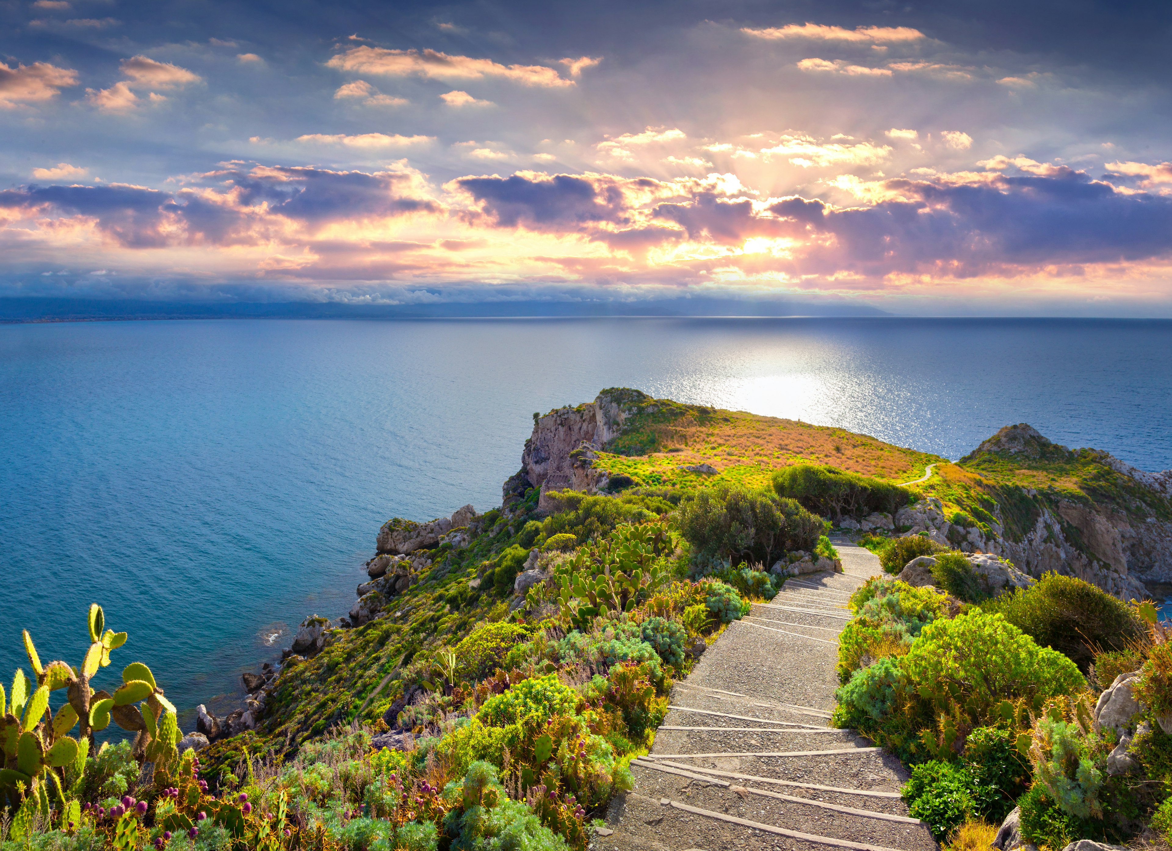 Colorful spring sunset on the Cape Milazzo, nature reserve Piscina di Venere, Sicily, Italy, Tyrrhenian sea.