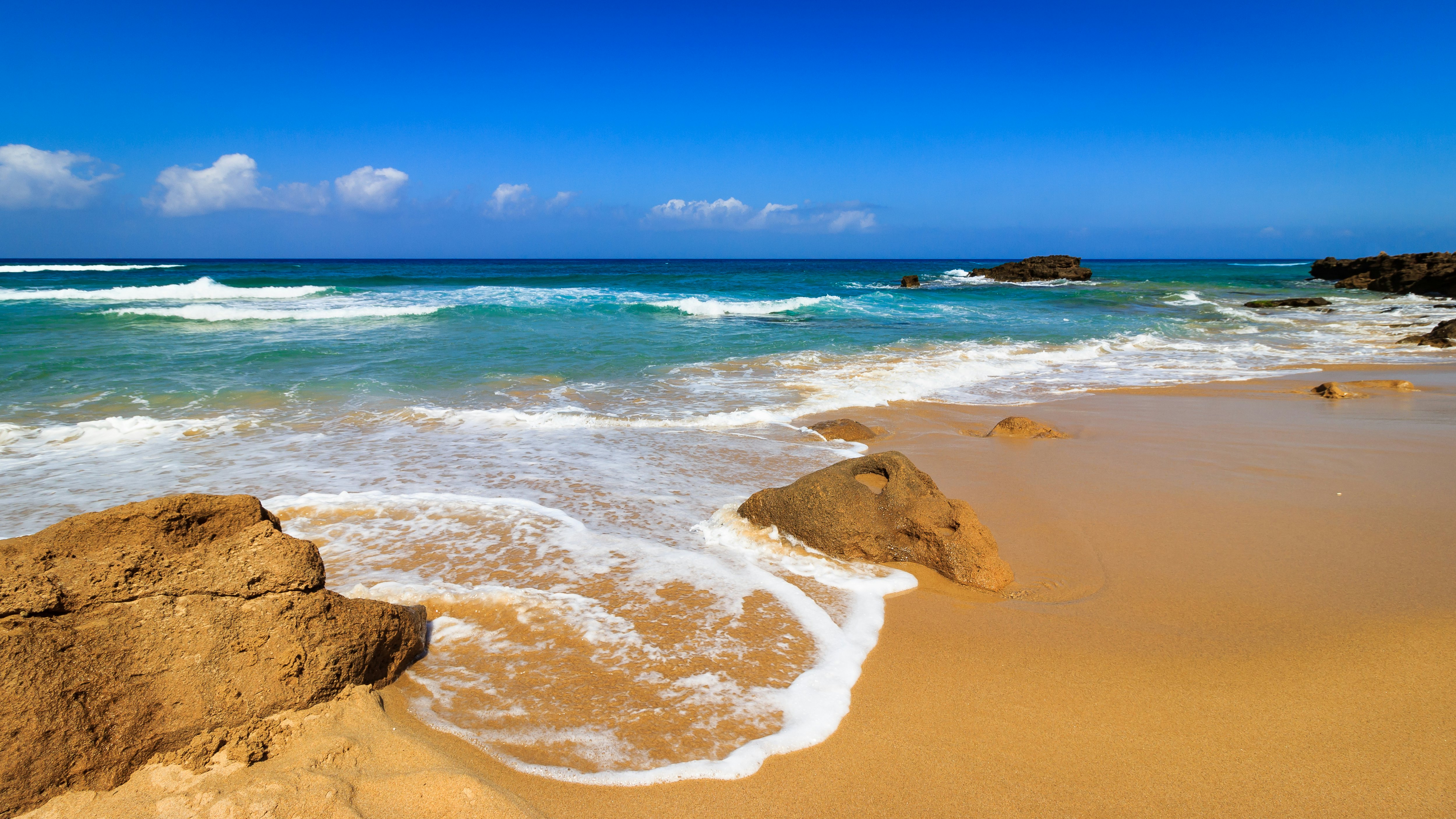 Waves hit the shore of Spiaggia di Piscinas in Sardinia.