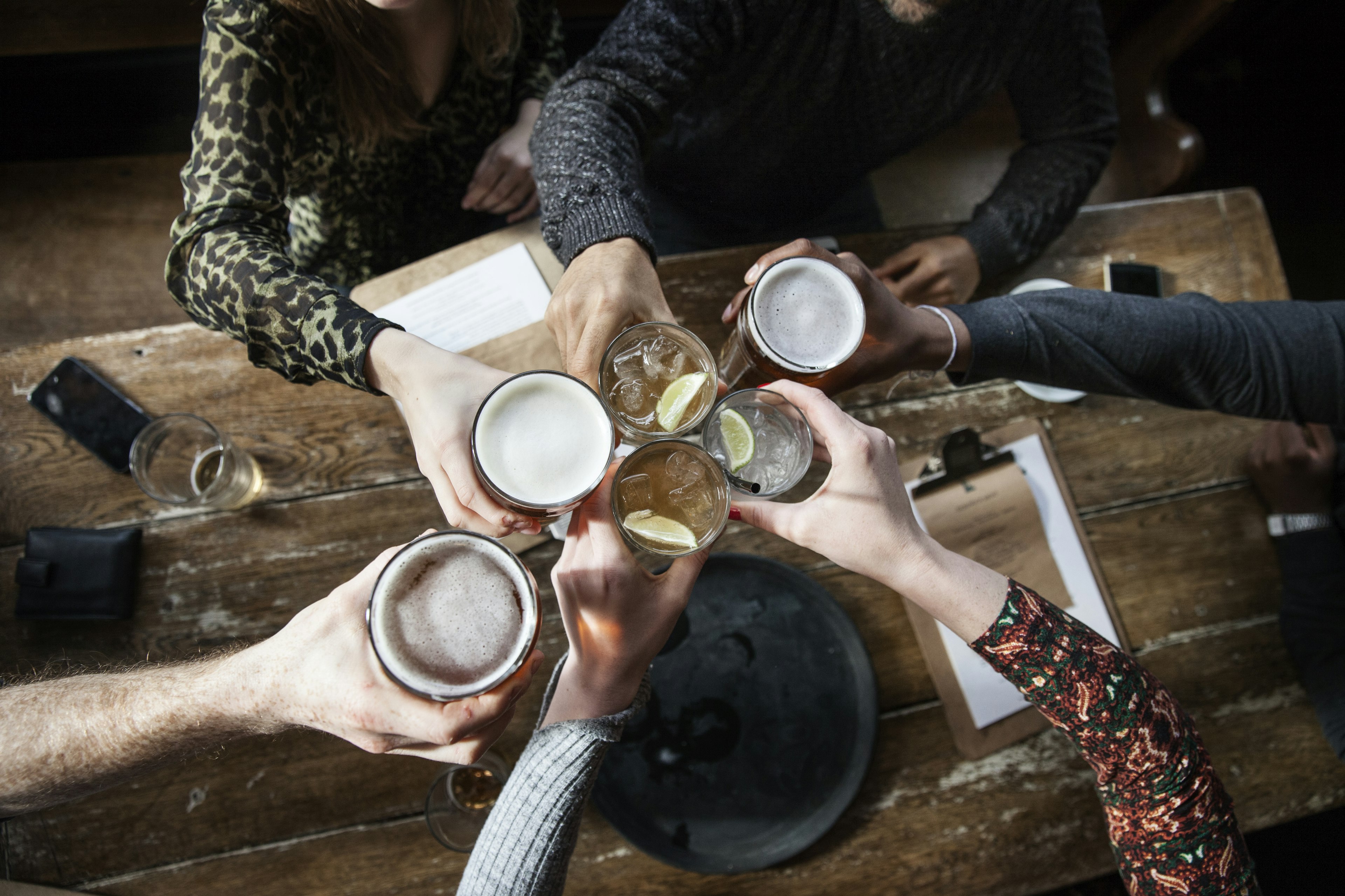 A close up of pint glasses mid-'cheers'