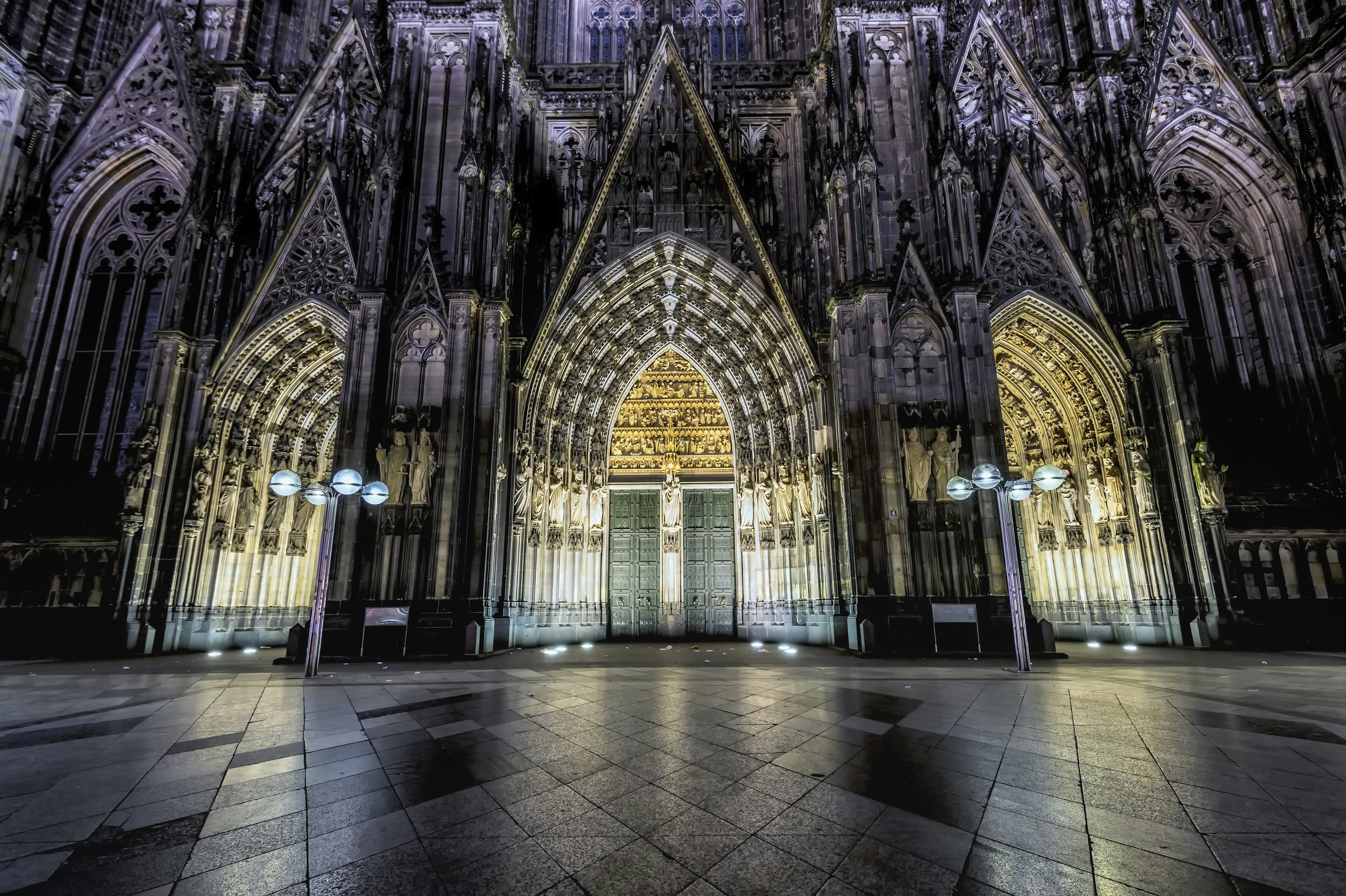 Doors of the Cologne Cathedral illuminated at night.
arch