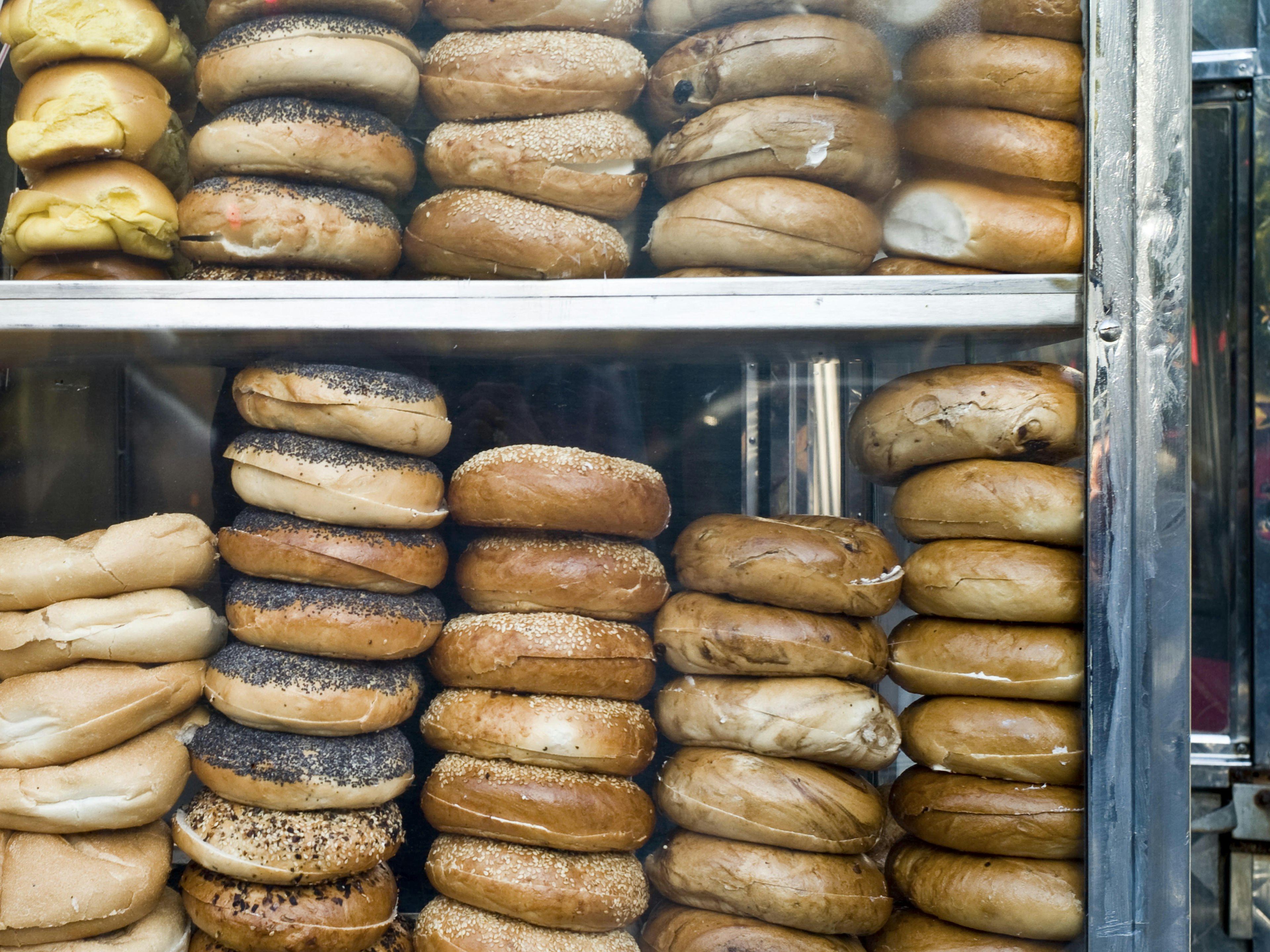 Stacks of bagels in a window.