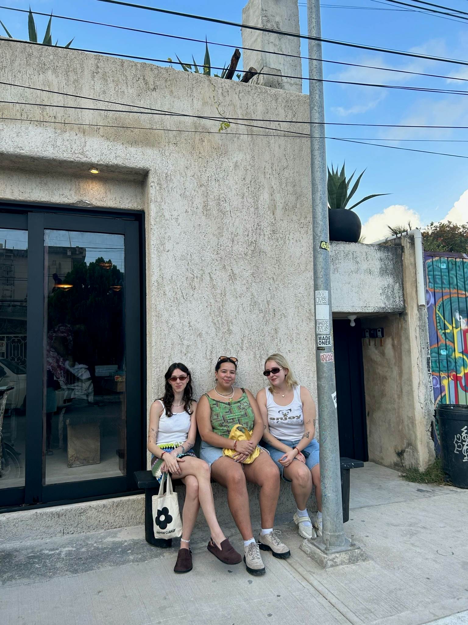 Three friends sat outside a hotel
