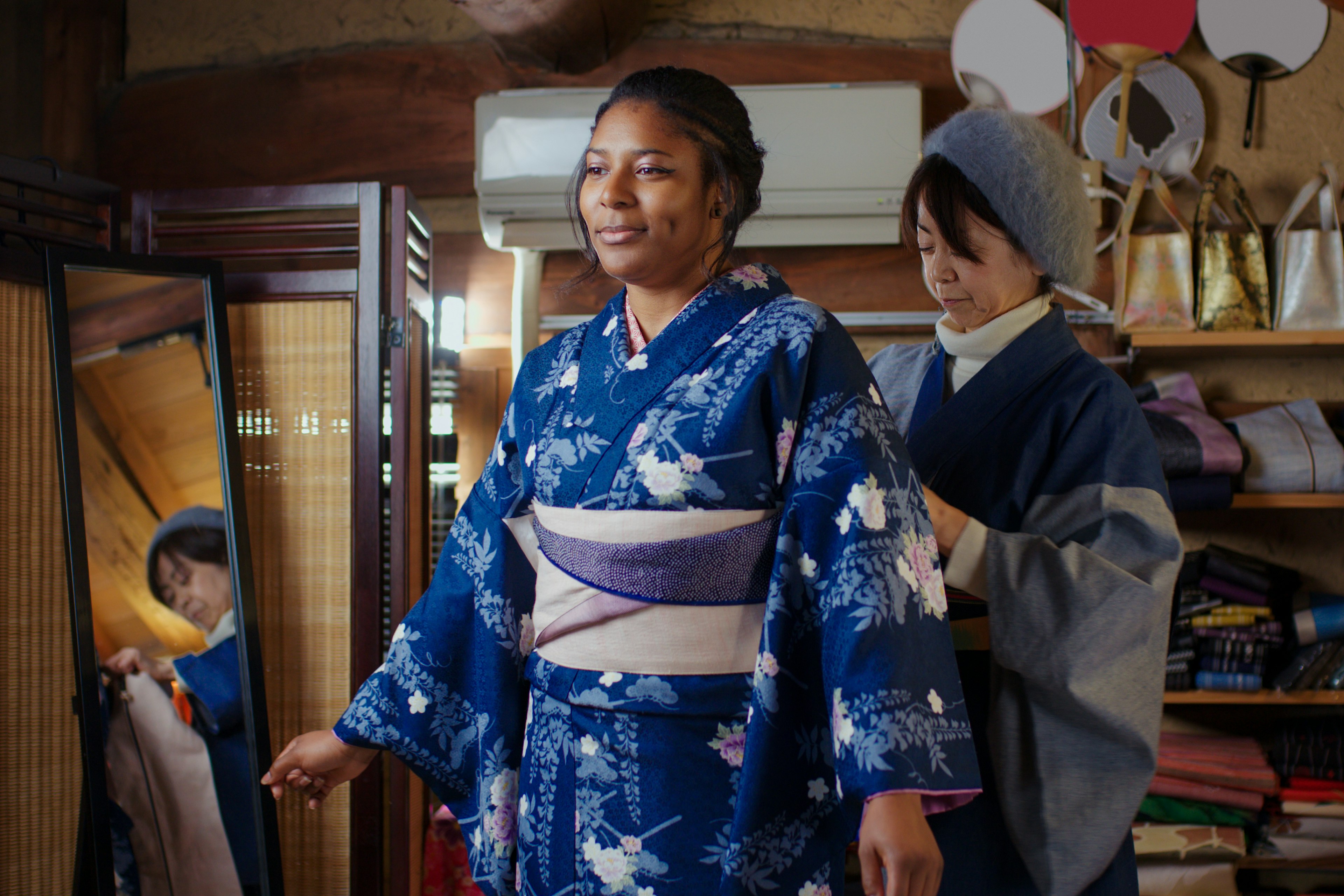 A Black woman tourist trying on a kimono in Japan.