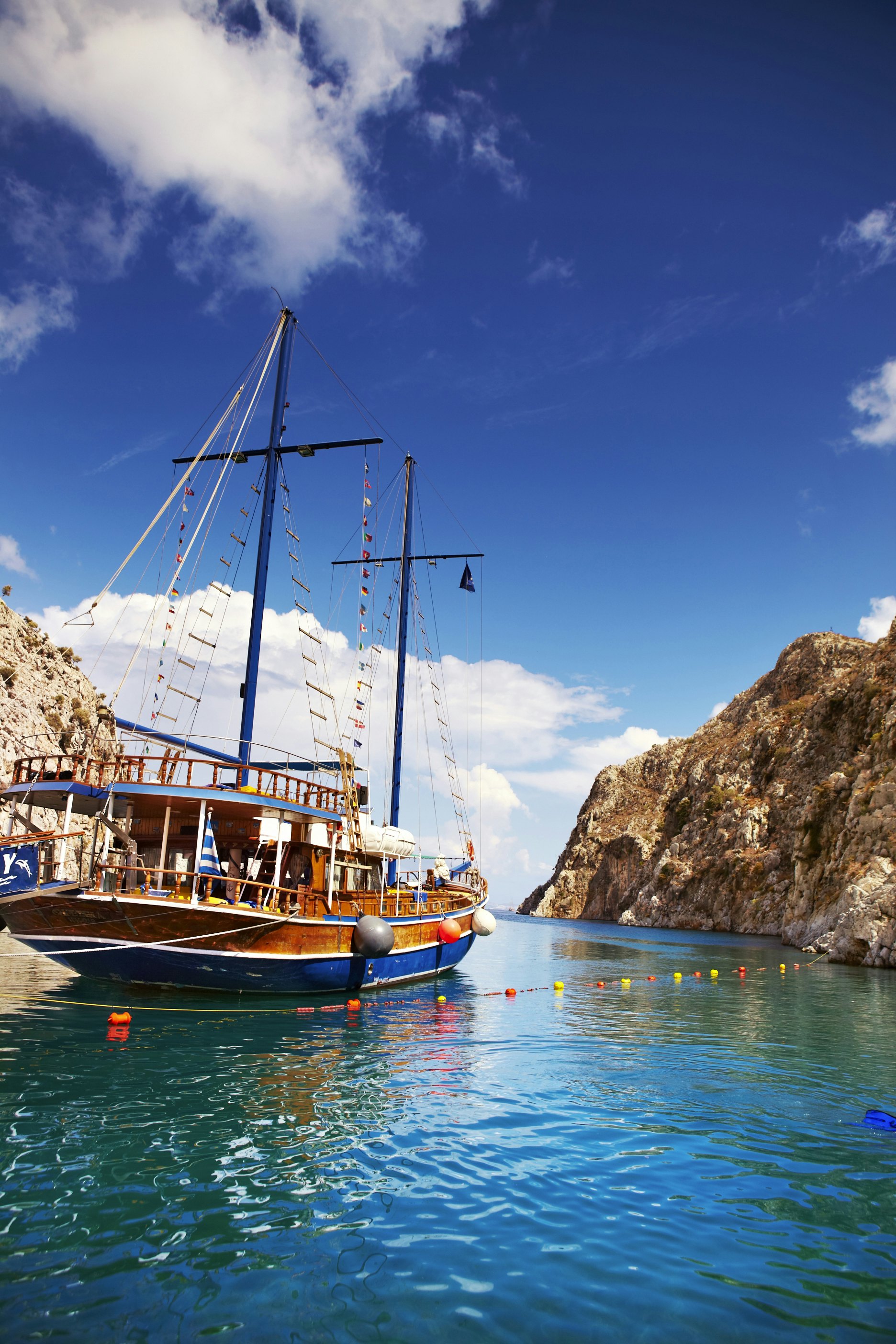 Island-hopping yacht moored in secluded cove.