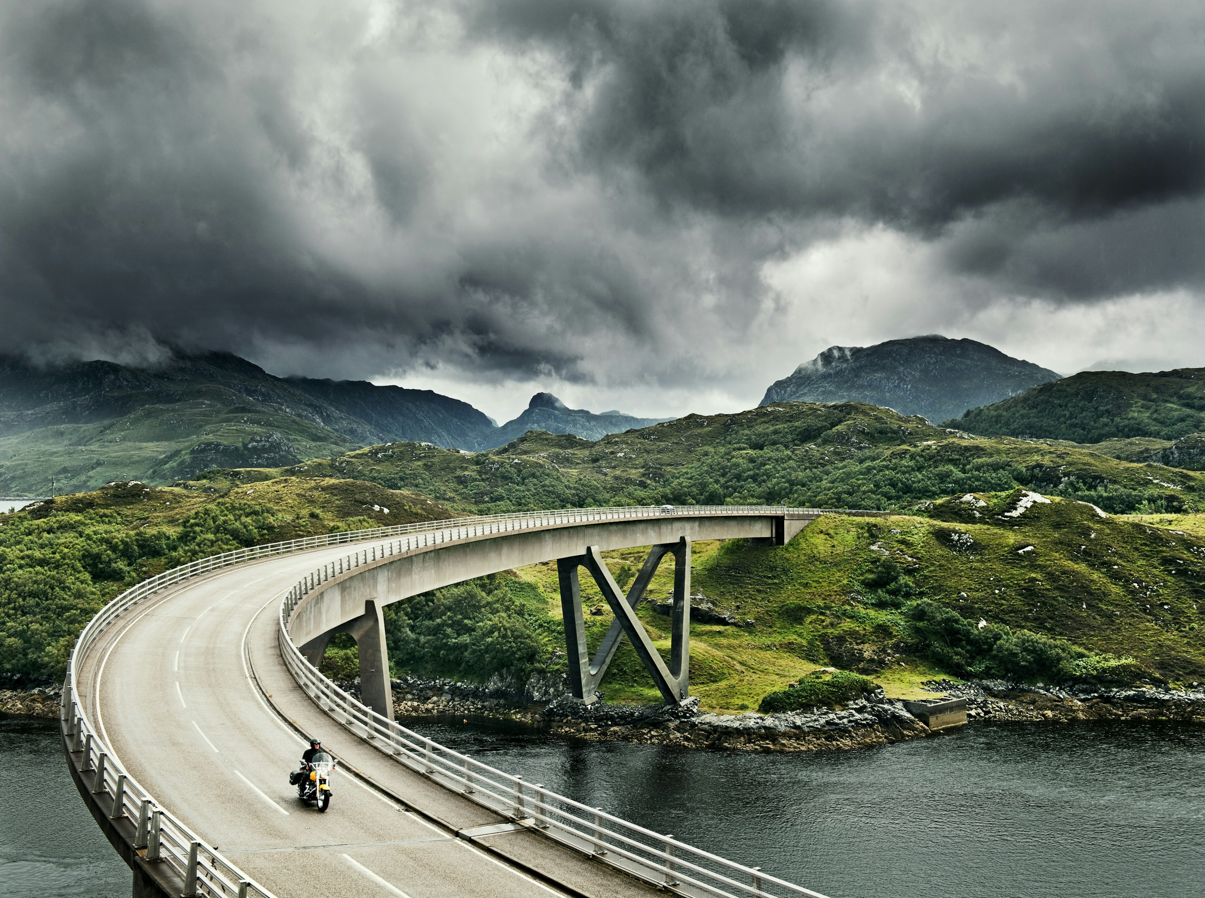 Motorbike crossing Kylesku Bridge.