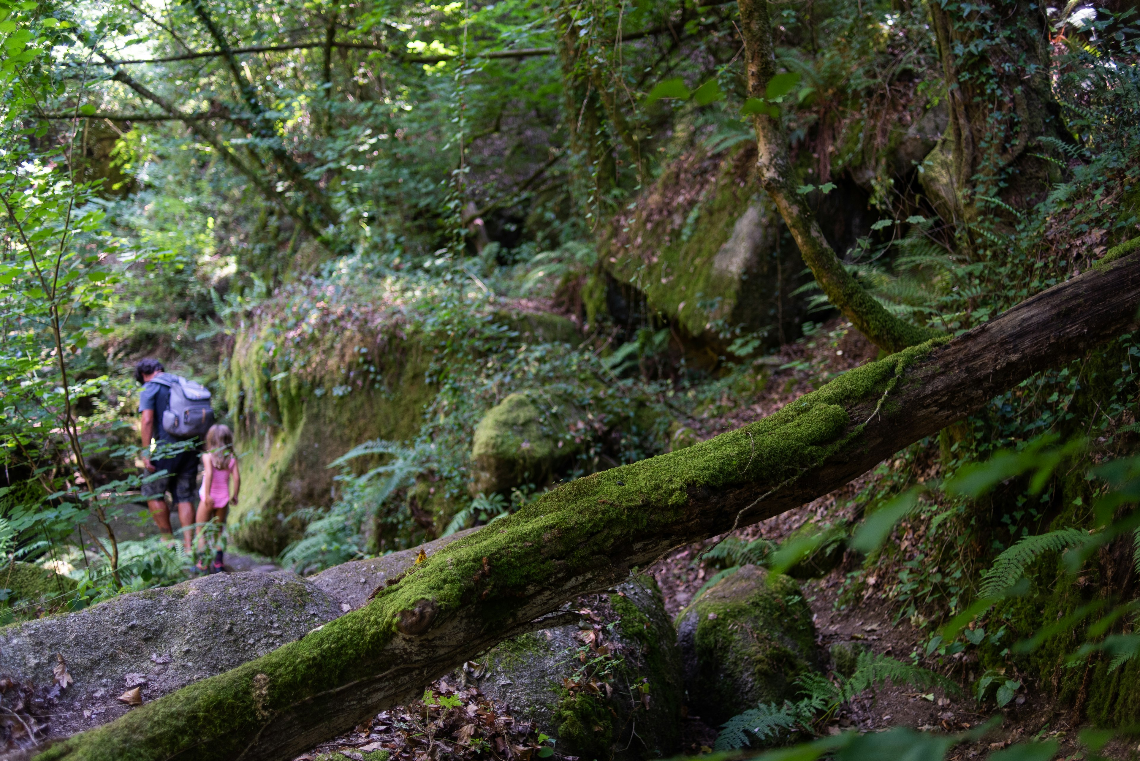 A father and daughter hike near Geres, Portugal.