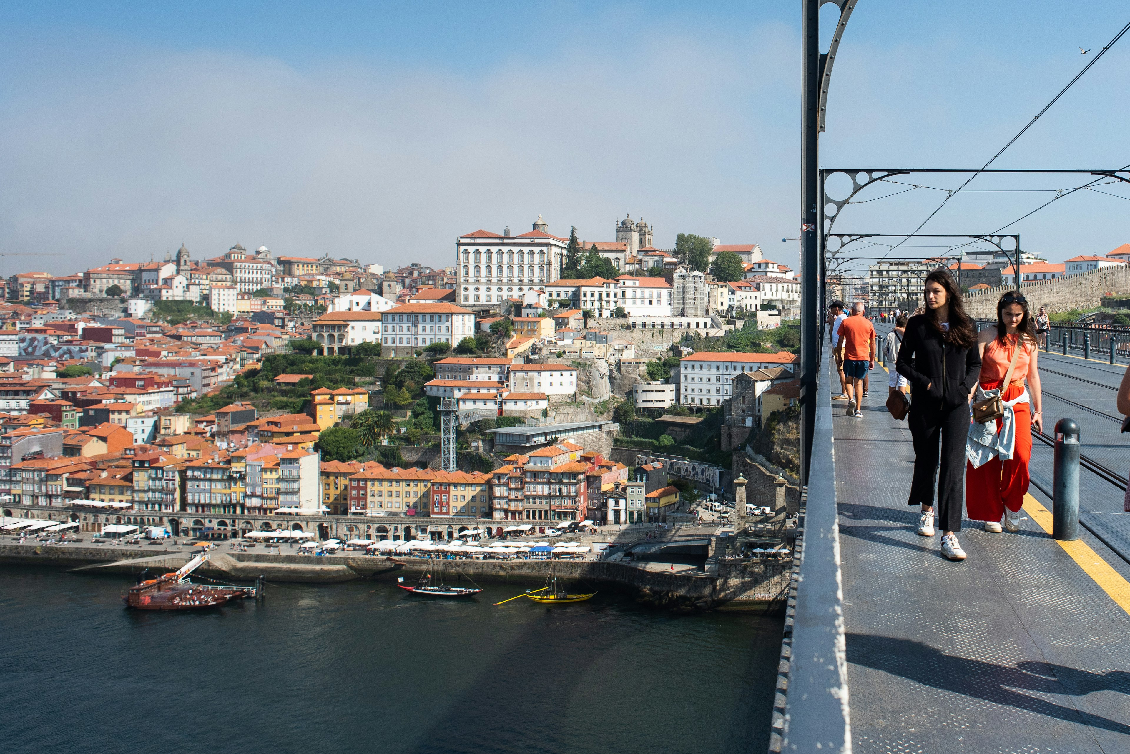 People walk across the Ponte de Dom Luís I bridge to Vila Nova de Gaia.