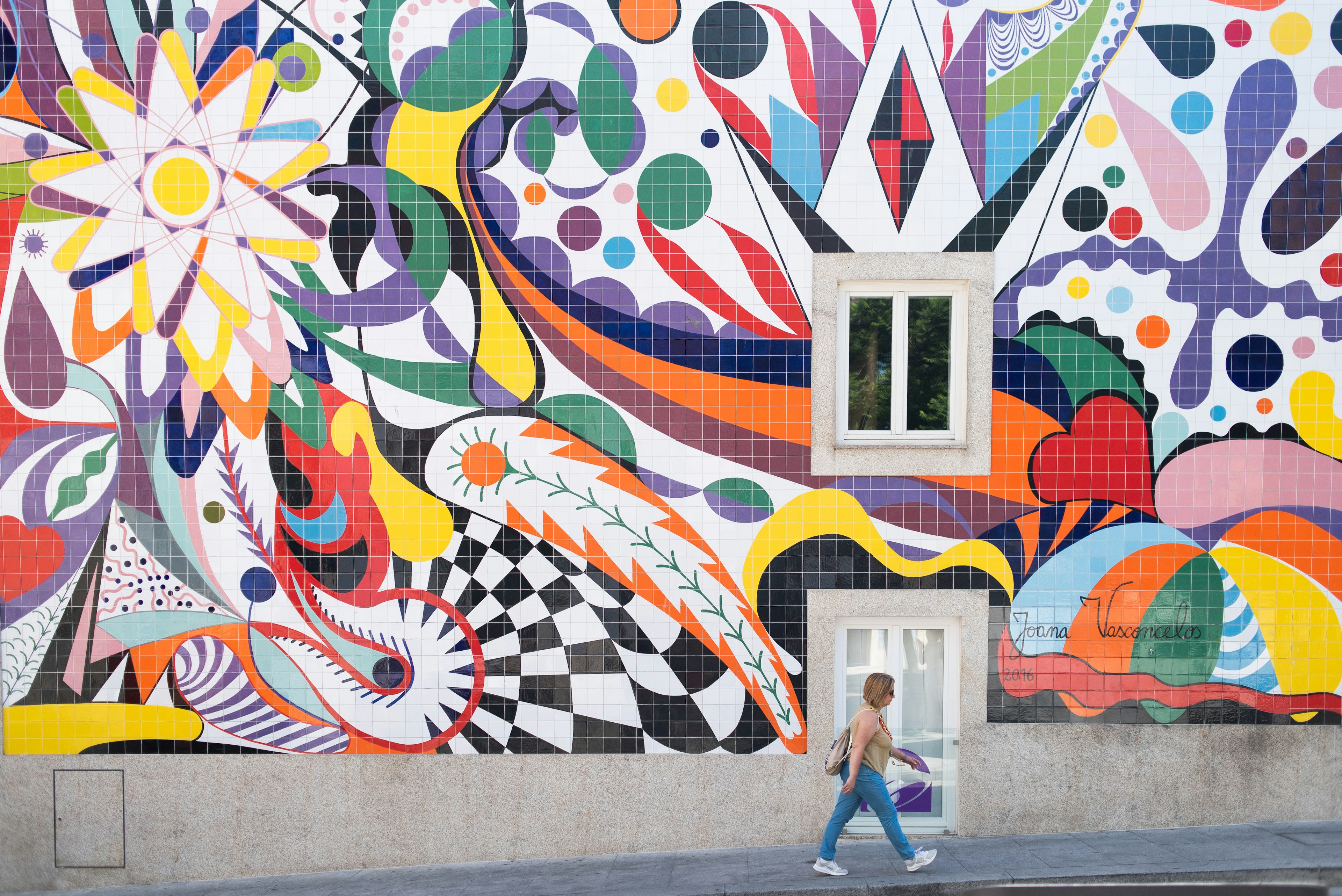 A colorful mural on the side of a building in Porto